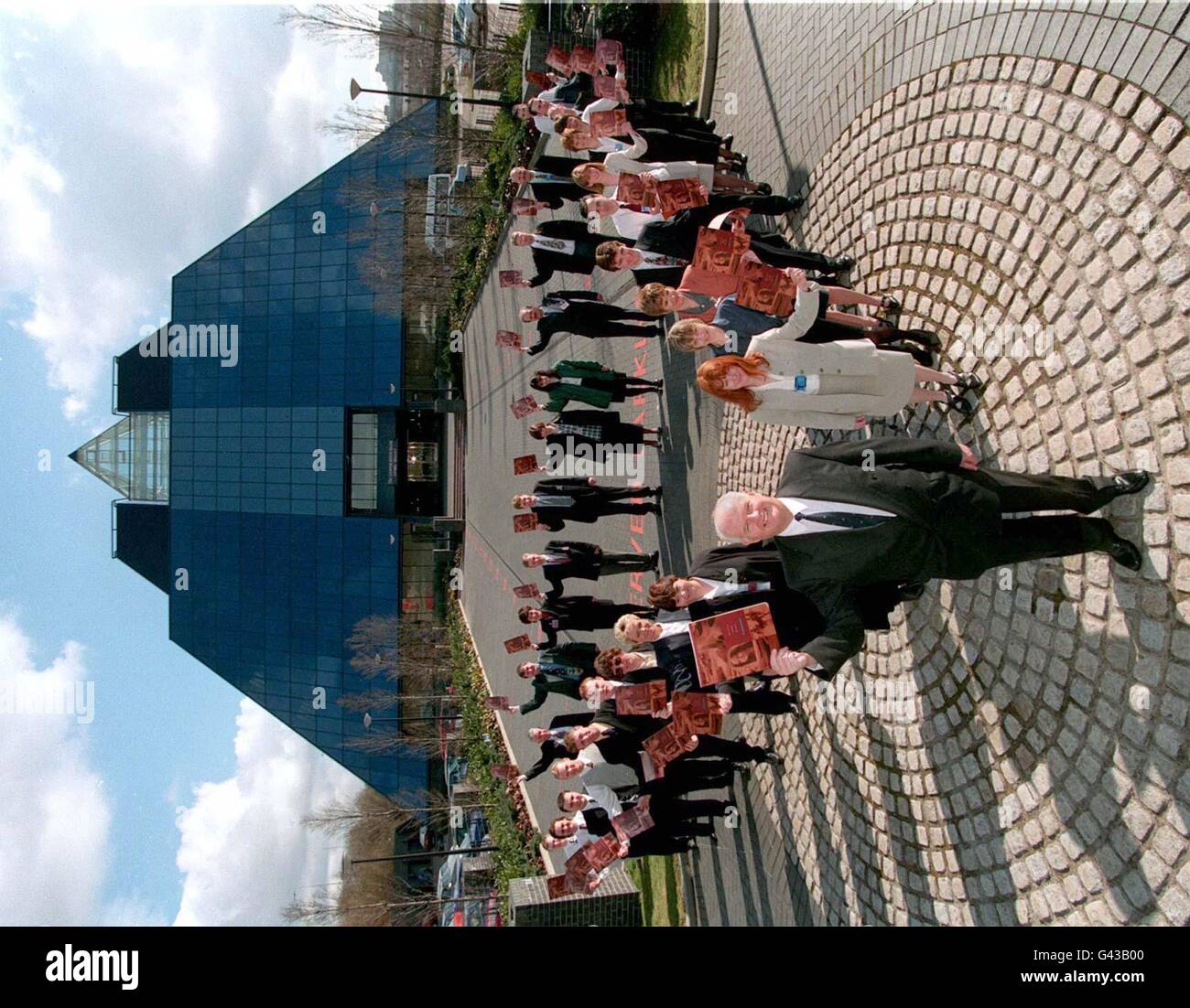 Terry Thomas (foreground), managing director of the Co-operative Bank, which today (Wednesday) announced pre-tax profits of 36.7 million, welcomes the first of 425 new staff to the bank's second telephone banking centreat the famous pyramid in Stockport. The call centre in the 120ft blue glass building will enable the bank to handle upto 12 million incoming calls a year by the year 2000. PA. SEE PA STORY CITY Co-op Stock Photo