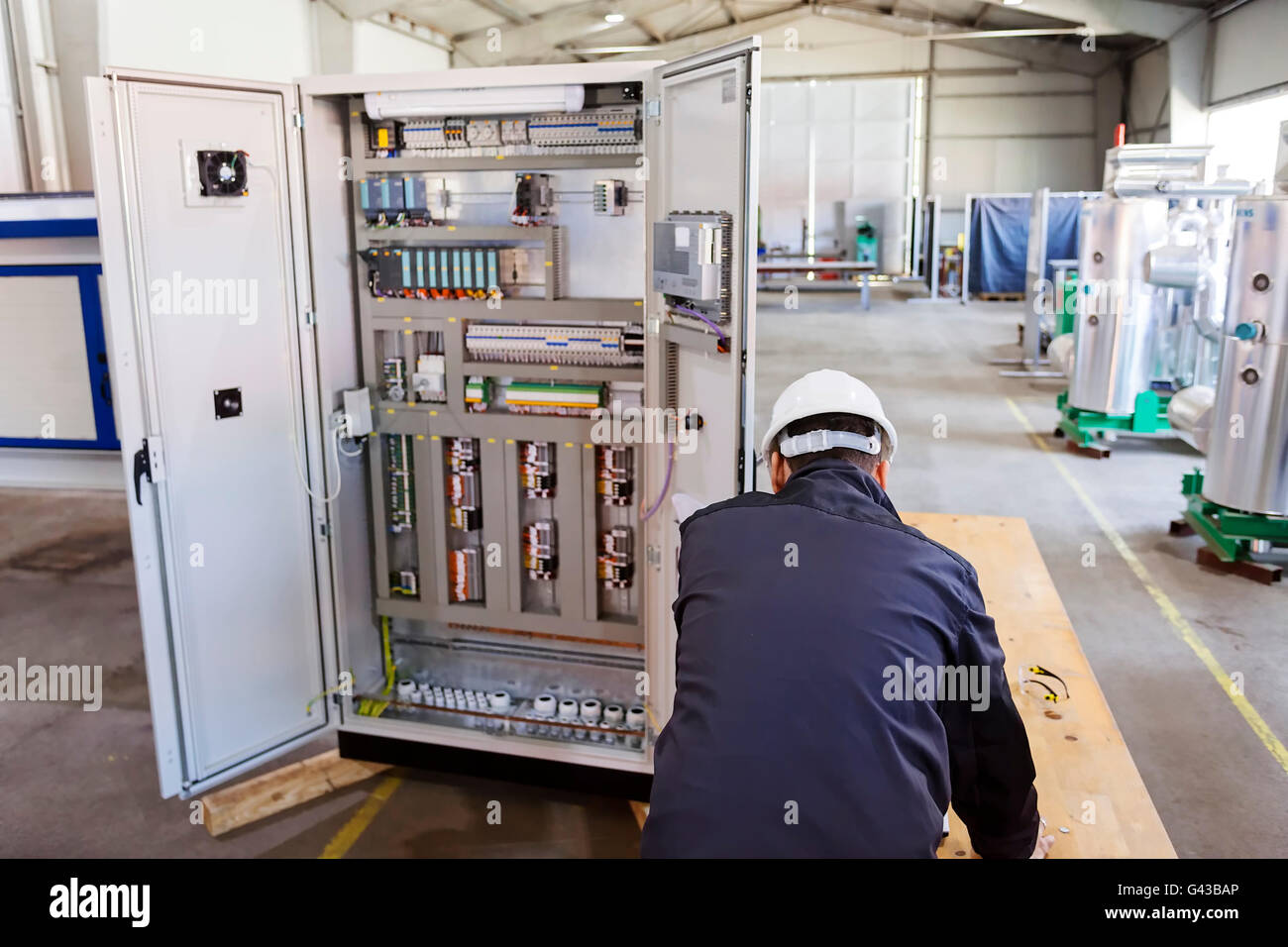 Man worker checking advanced industrial control panel in the production ...
