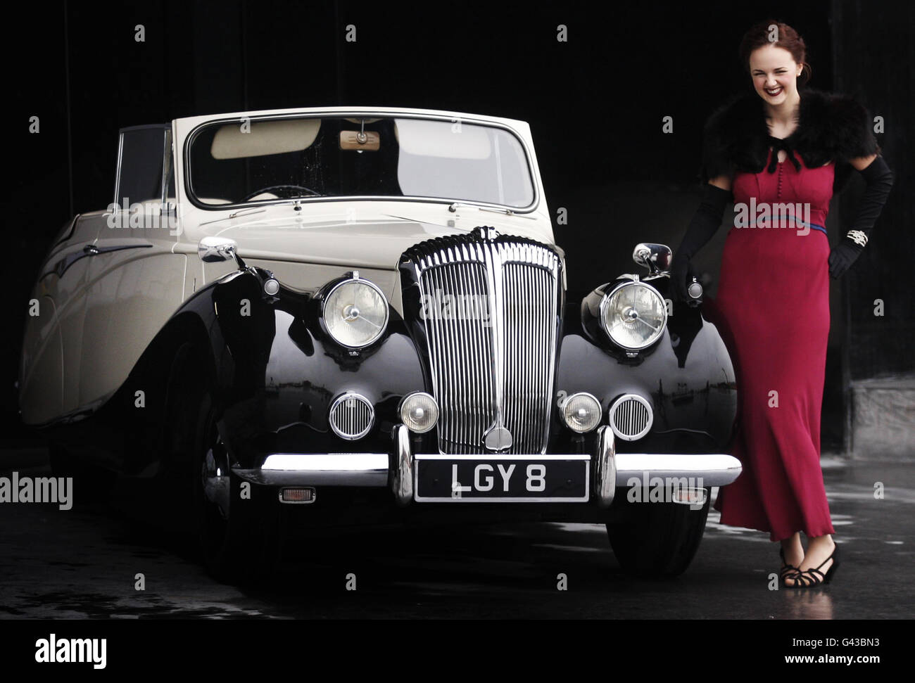 Model Lauren Abercrombie with a 1950s Daimler that was owned by King George VI, outside the Riverside Museum in Glasgow. Stock Photo