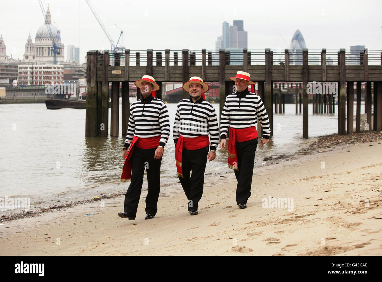 The Gondoliers (left to right) Michele Bozzato, Michael Malvich and Luca Foffano during a photocall as they sign a record deal with Universal Music - which will raise money and awareness for Venice in Peril, the fund working to save the Italian sinking city - on the South Bank in London. Stock Photo