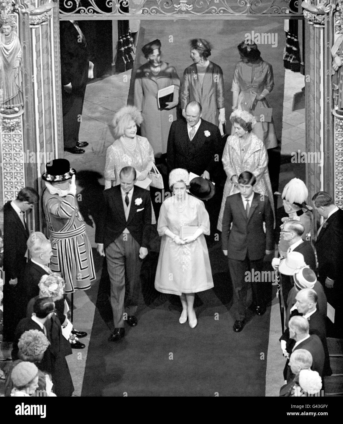 Queen Elizabeth II, the Duke of Edinburgh, and Prince Charles, walk down the aisle at Westminster Abbey, following the wedding of Princess Alexandra and Angus Ogilvy. Stock Photo