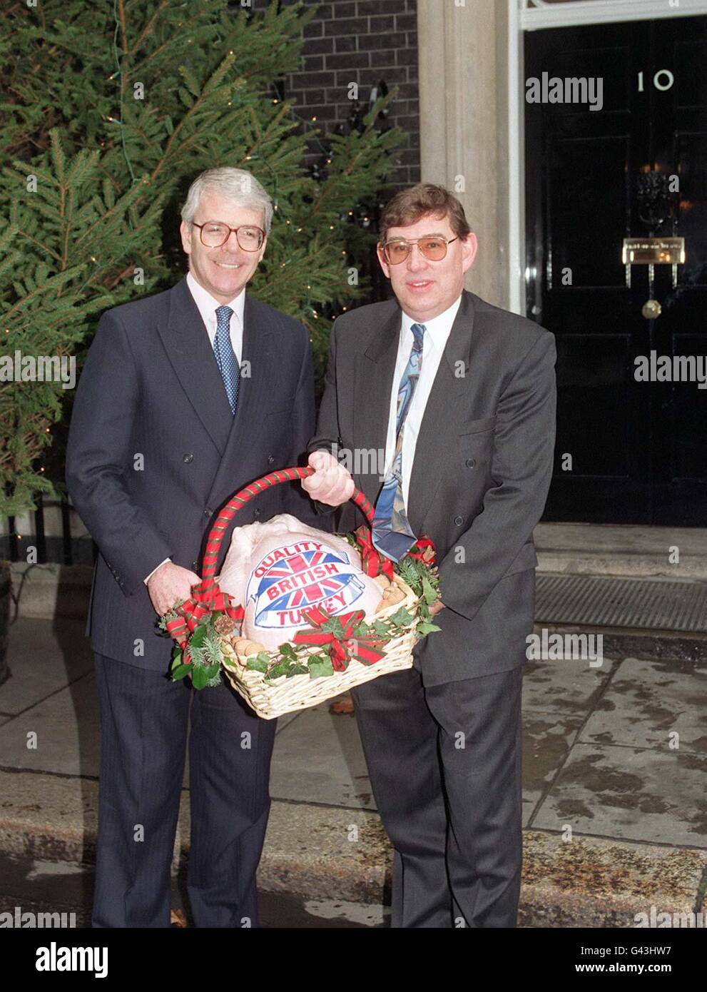Mike Boon, frpm th British Turkey Federation, presents the Prime Minister John Major (left) with the traditional gift of a Christmas turkey outside No 10 Downing Street. NS ROTA POOL Stock Photo