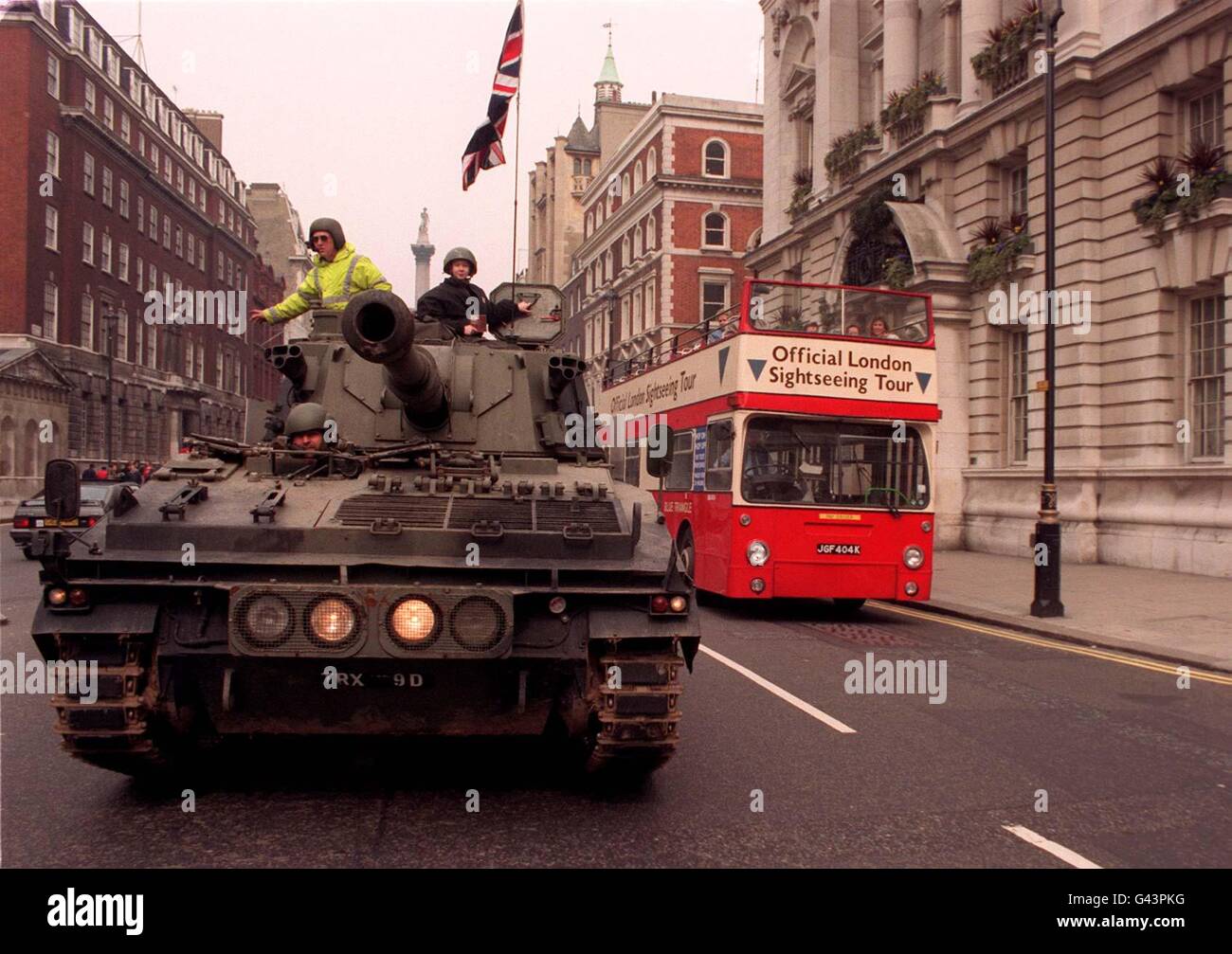 Fourteen-year-old Leo Lester, in turret on right, drives a World War II tank along Whitehall today (Sunday) on his way to Downing Street to deliver a copy of the new 'Images of War' CD-ROM to Number 10. The highly evocative and comprehensive CD-ROM covers 35 major battles of World War II and includes eyewitness accounts of the horrors and casualties of war. Stock Photo