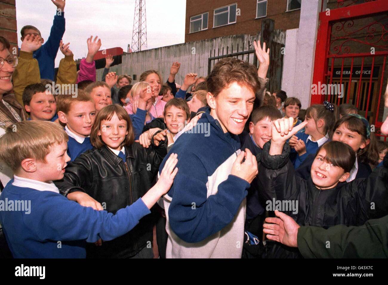 Touching their hero, children from the Sacred Heart Primary School, which adjoins the Middlesbrough Training Ground, mob the club's new signing Juninho of Brazil after he completed his first full traing sesion with the team behind locked doors. Stock Photo