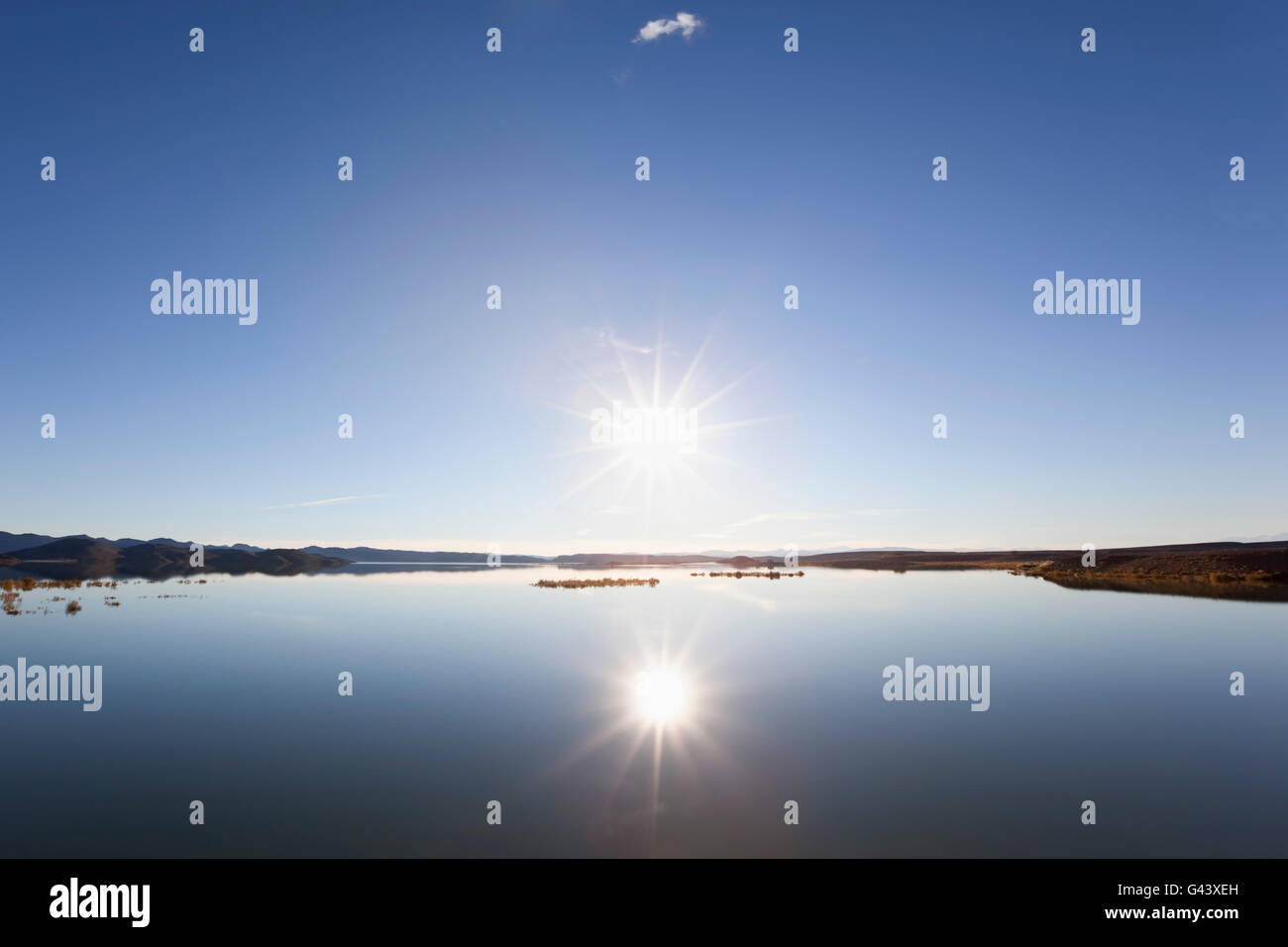 Sunset at a lake with clear blue sky and water reflection Stock Photo ...