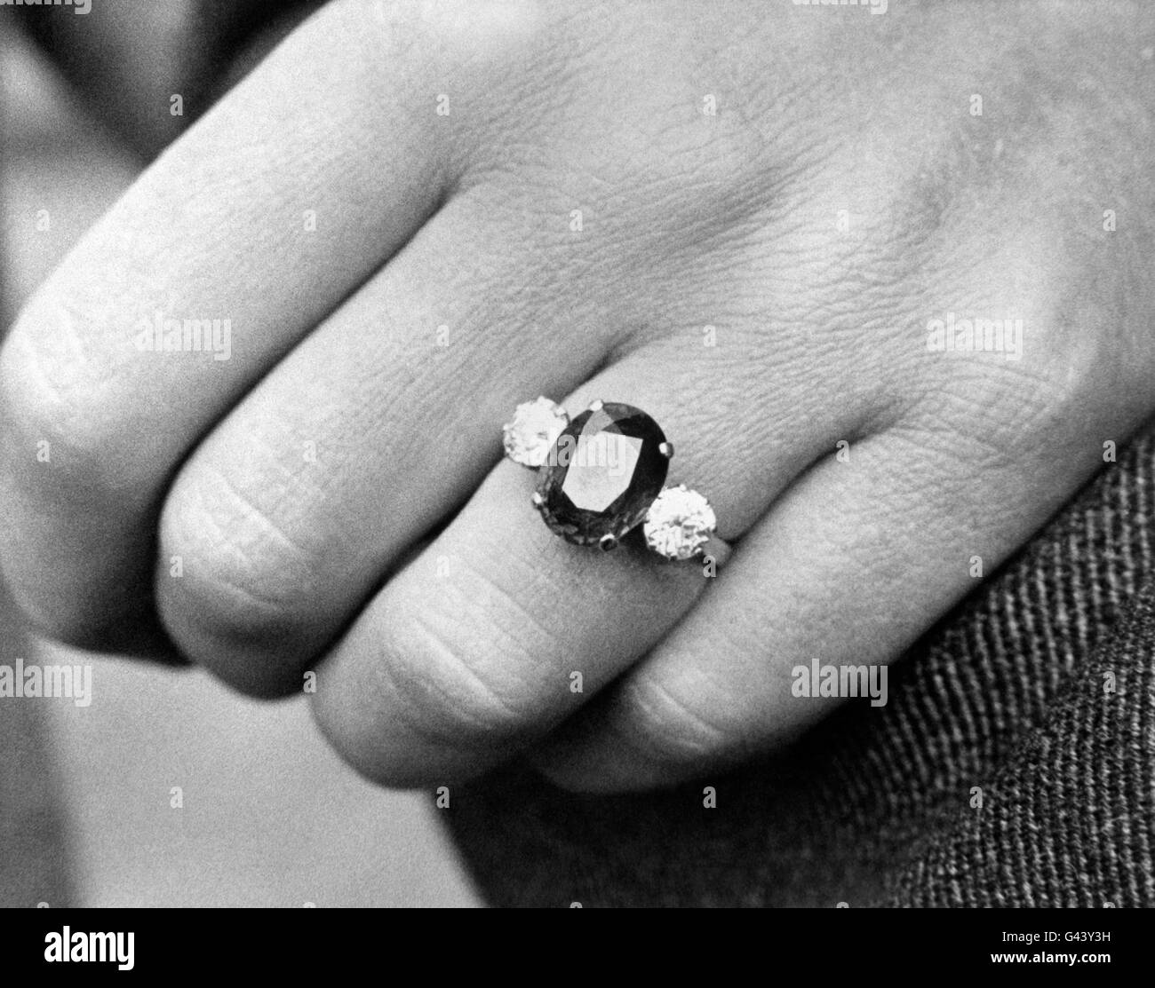 The Duke of Kent s engagement ring is pictured on the finger of his fiancee Katharine Worsley. It comprises a large sapphire with a single brilliant diamond on each side mounted in platinum