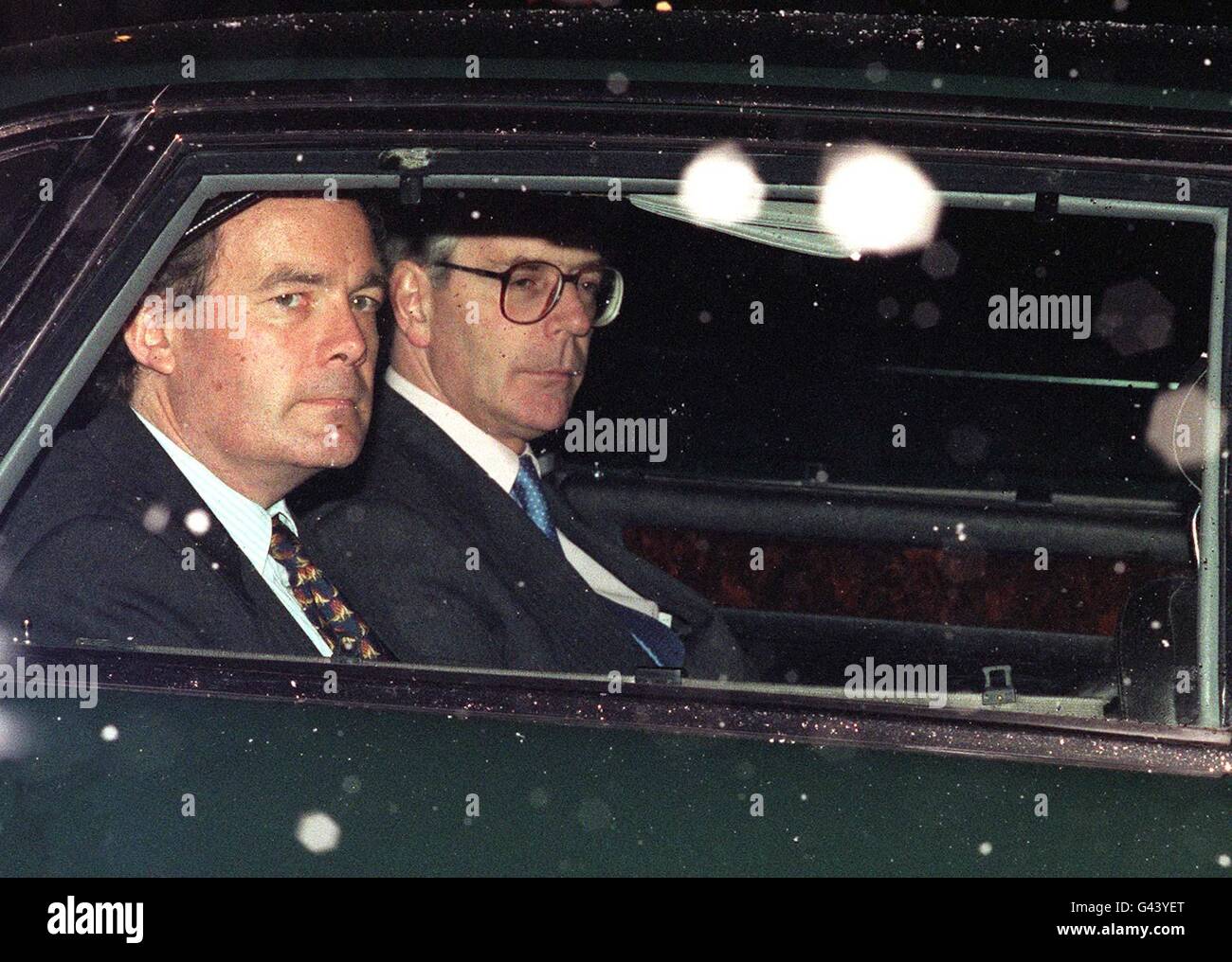 Prime Minister John Major (right) is driven out of Buckingham Palace this evening (Tuesday) in a snow shower following his weekly audience with The Queen. Palace officials were tonight remianing tight-lipped on whether the pair had discussed the future role for the Princess of Wales. **MAN ON LEFT UN-IDENTIFIED** Stock Photo