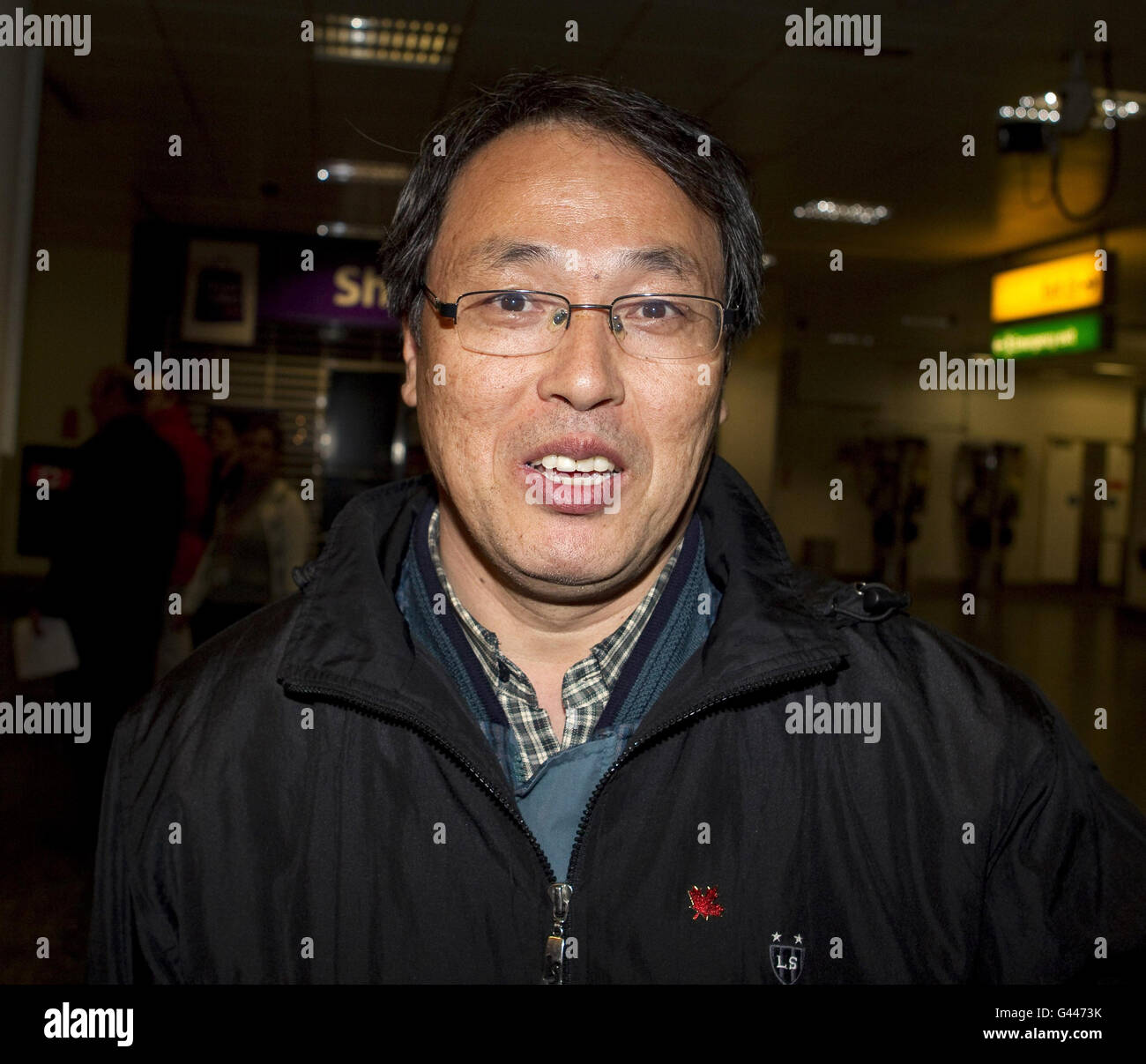 Oil worker James Kim, 55, arrives at Gatwick airport on a Government-chartered plane from Libya. Stock Photo