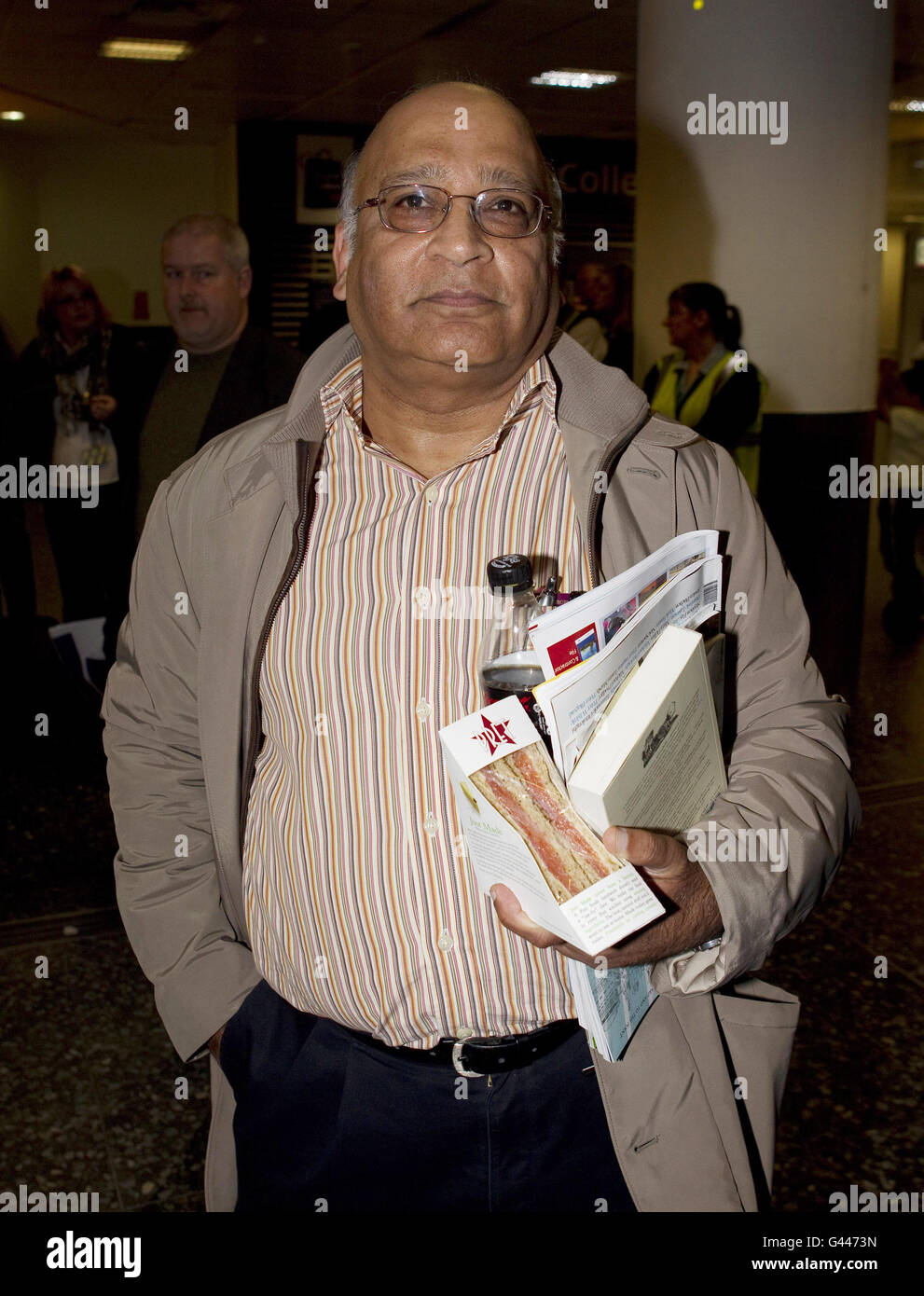 Iftikhar Ulhak, 59, a chemical engineer who lives in Wimbledon arrives at Gatwick airport on a Government-chartered plane from Libya. Stock Photo