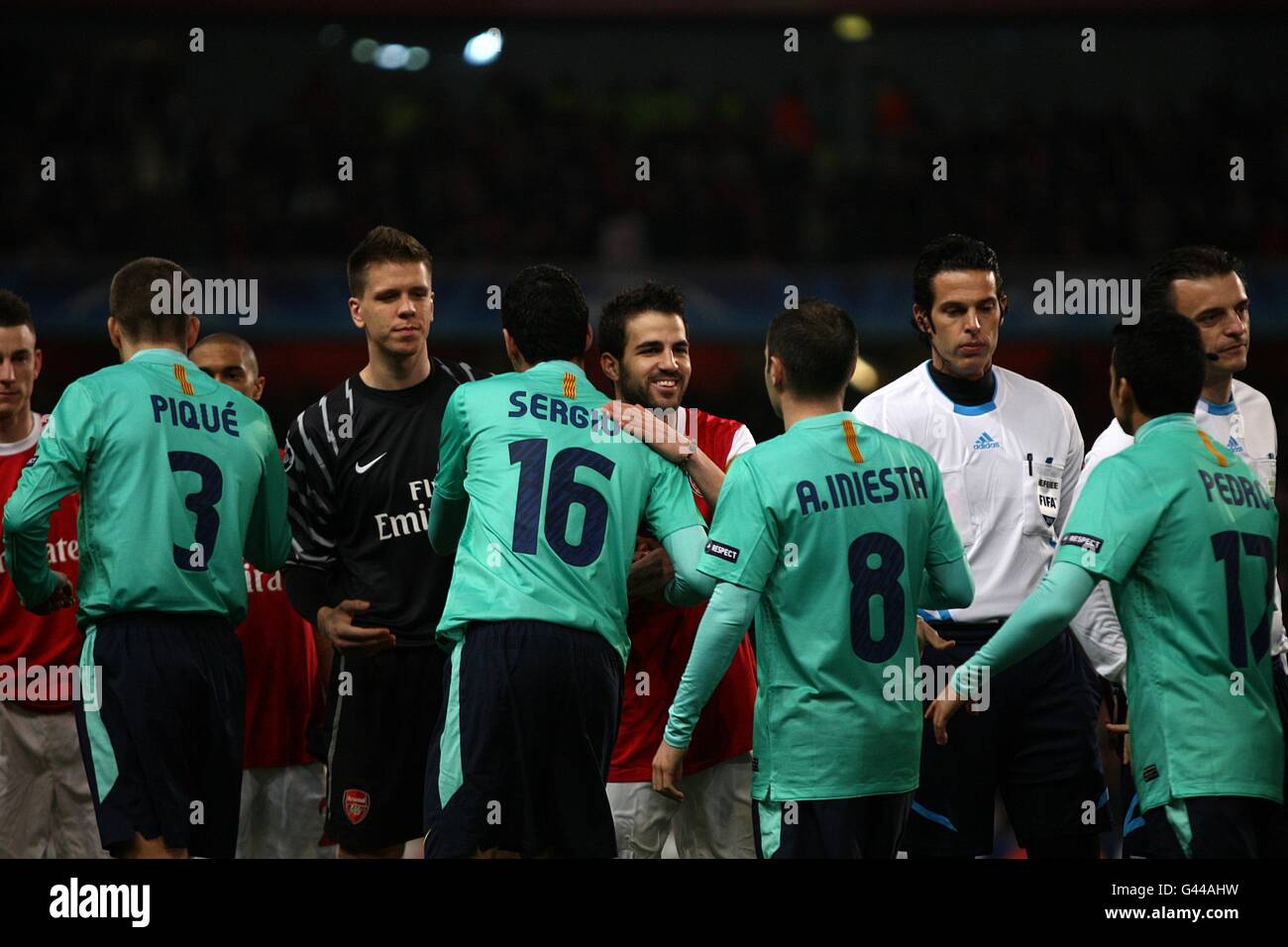 Arsenal's Francesc Fabregas (centre) shakes hands with Barcelona's