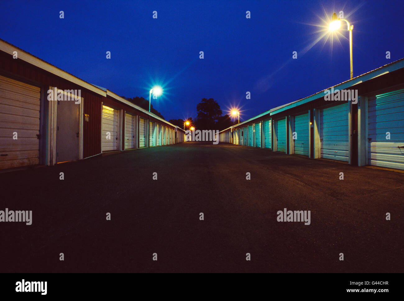 Night view of garage like rental storage units lined up in a row Stock