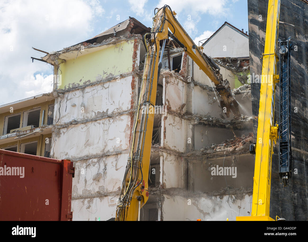 Dismantling of Building crashing by machinery Stock Photo