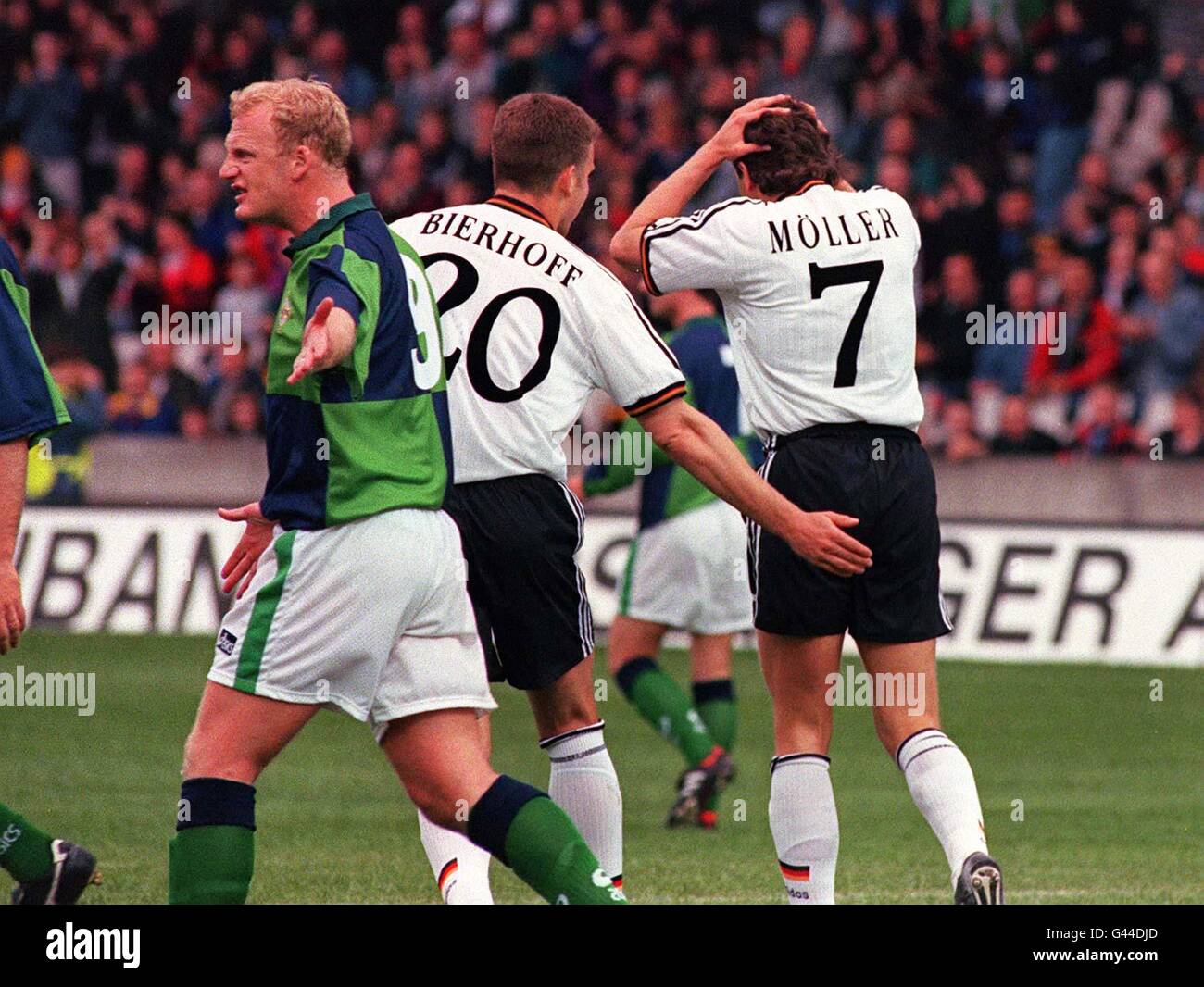 Northern Ireland's Iain Dowie argues a point as Andreas Moller of Germany is consoled by Oliver Bierhoff after he missed a penalty, the second penalty miss in the first half of their International friendly in Belfast. Stock Photo