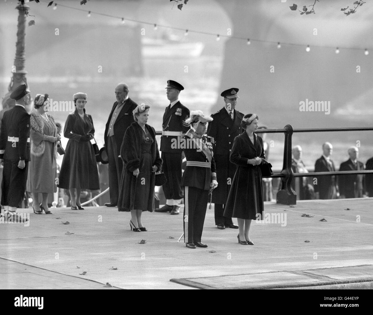 London had a Royal welcome for general Francisco Craveiro Lopes, President of Portugal, Britain's oldest ally, on his arrival at Westminster Pier for his state visit. With Queen Elizabeth II, General Lopes stands at the salute as the national anthems are played. With them are Senhora Dona Berta Craveiro Lopes, the Duke of Edinburgh, Princess Margaret, the Queen Mother and, in the background, Lord Waverley. Stock Photo