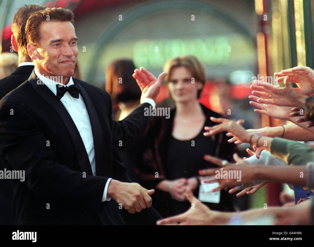 Fans reach out to shake hands with American actor Arnold Schwarzenegger in London for the UK premiere of his latest film 'Eraser' at the Warner Bros. Cinema this evening (Wednesday). Photo by Adam Butler/PA. Stock Photo