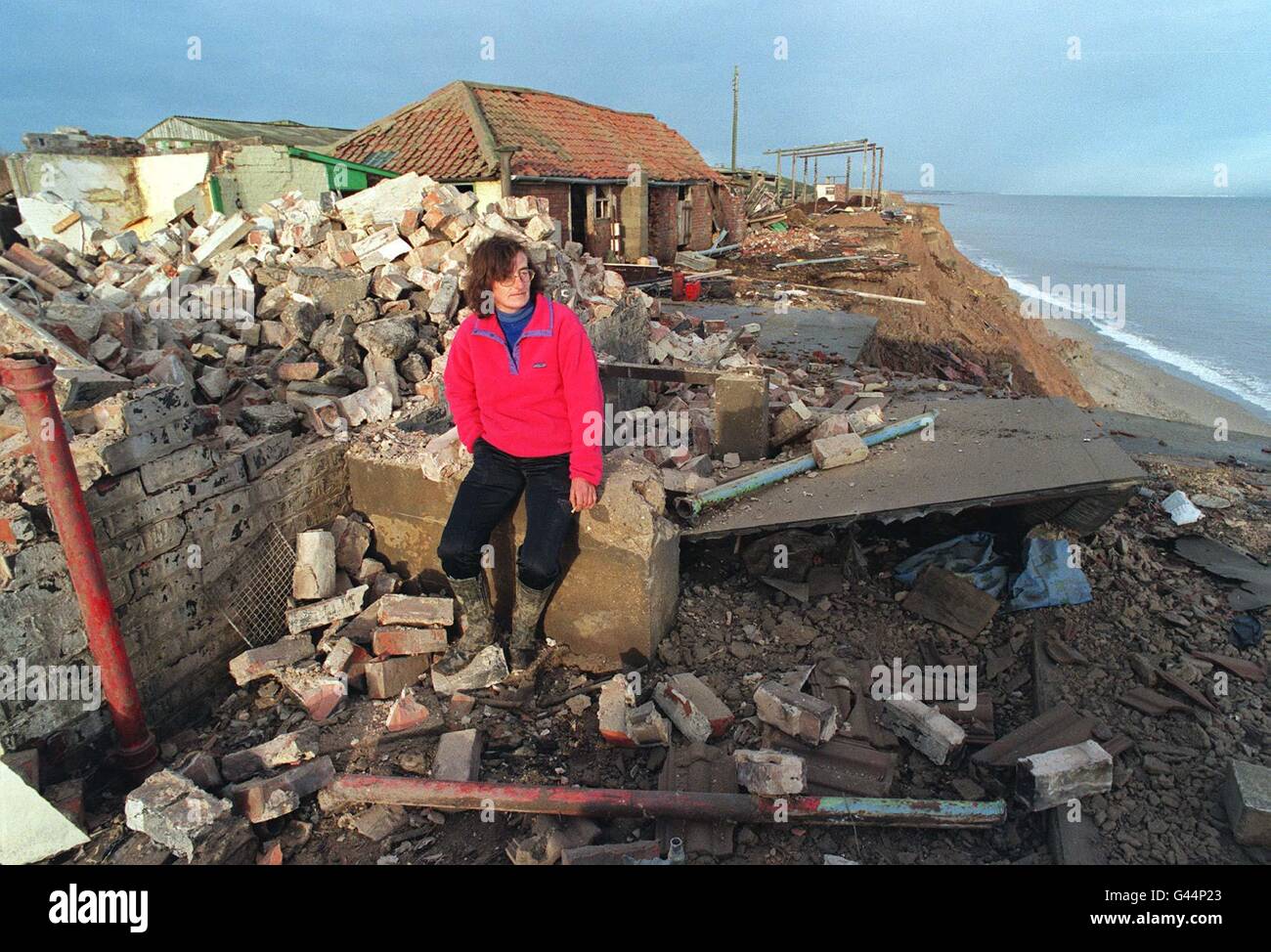 Sitting amongst the wreckage of her home, Sue Earle of Great Cowden, near Hornsea, today (Fri) after the Council demolished her farmhouse, which was standing on the edge of a cliff. She will have to pay the bill for the demolition. Photo John Giles.PA. Stock Photo