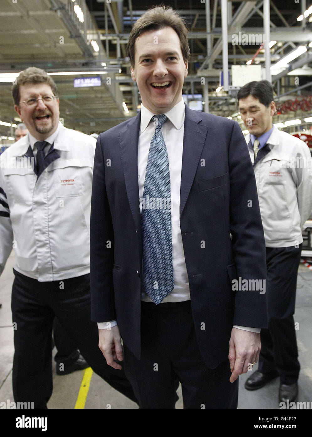 Chancellor of the Exchequer, George Osborne (centre), speaks with managing Director Katsunori Kojima (right) and deputy managing Director Tony Walker during a visit to the Toyota factory in Derby. Stock Photo