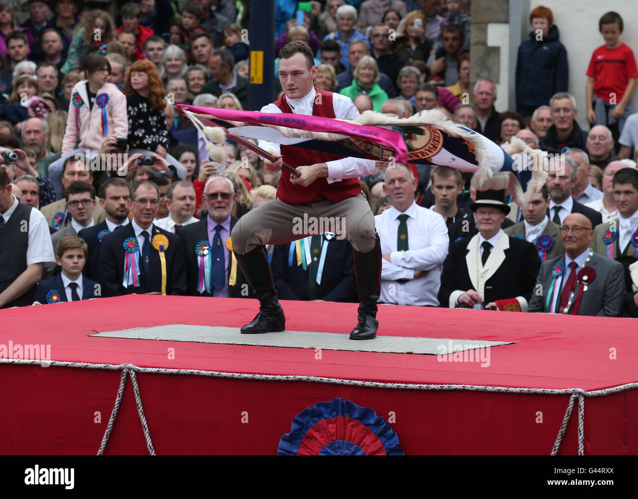 Royal Standard Bearer Rory J. Monks waves the burgh flag during a ceremony in the Selkirk's Market Place during the Selkirk Common Riding, a centuries-old tradition in the royal burgh in the Scottish Borders. Stock Photo