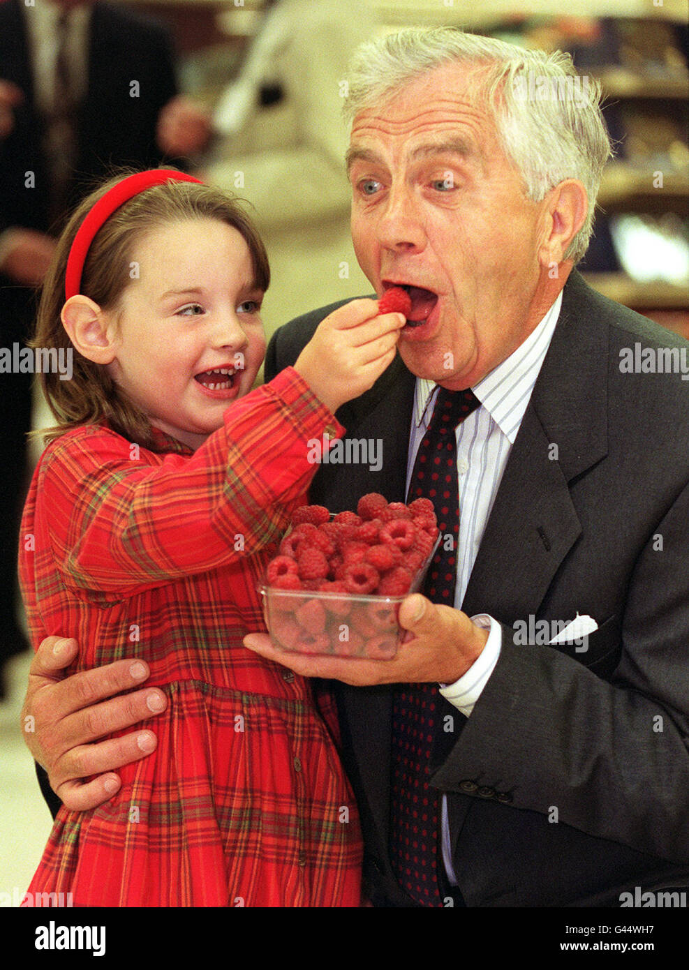 Four-year-old Terri-Louise Jennings, from Blairgourie, Perthshire, feeds a giant raspberry named in her honour to her grandfather, fruit breeder Derek Jennings. The Terri-Louise raspberry, which was launched by food giant Marks & Spencer today (Friday), was described as 'succulent, highly flavoured and on average double the size of any of its rivals'. See PA story CONSUMER Raspberry. Photo by Michael Crabtree/PA Stock Photo