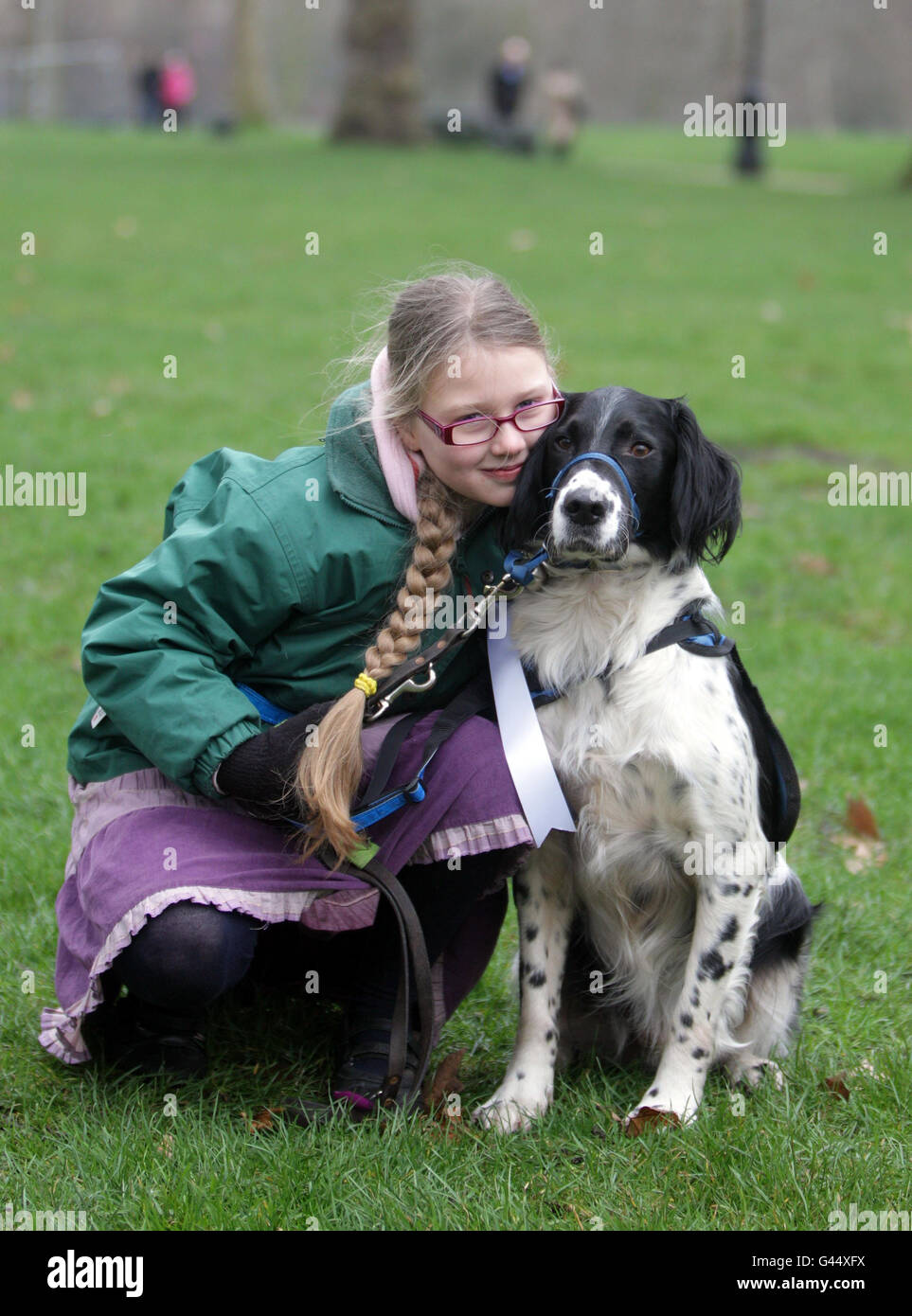 Grace Brown-Griffin, 10, with Merlin, a cross breed who works as a Support Dog for Grace who is autistic and has ADHD, during a photocall for the five finalists who are competing for the Crufts Friends for Life award in Green Park, London. Stock Photo