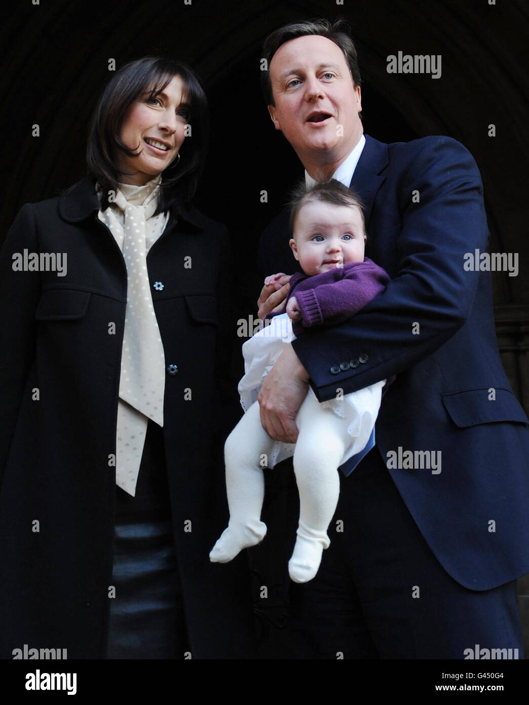 Prime Minister David Cameron and his wife Samantha with their daughter Florence Rose Endellion at St Mary Abbots Church in South Kensington, west London today, after the christening of their youngest child who was born in Cornwall last August. Stock Photo