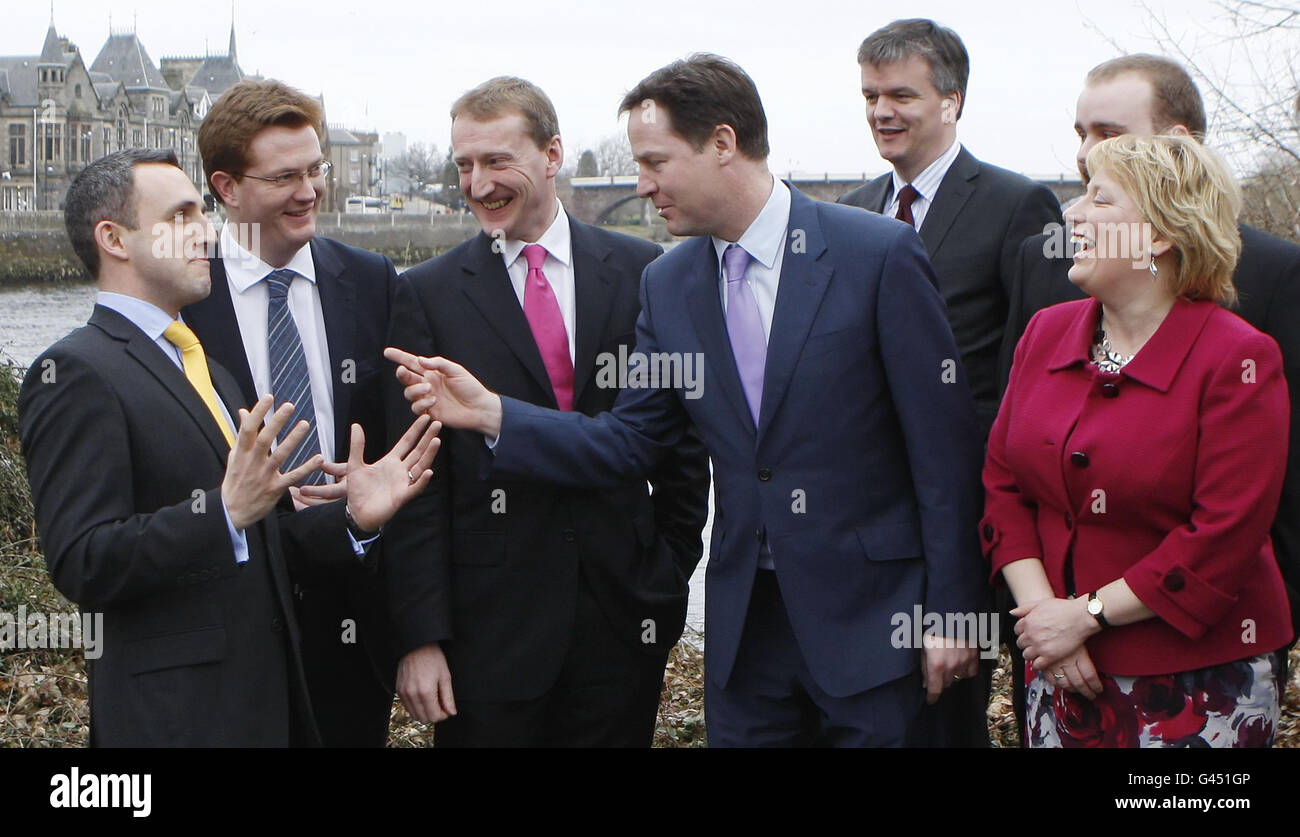 Nick Clegg, Liberal Democrats leader (centre), jokes with party members Alex Cole-Hamilton (left), Danny Alexander (2nd left), Tavish Scott (3rd left), Michael Moore (5th left), Callum Leslie (back right obscured) and Katy Gordon (front right), during a photocall by the River Tay in Perth, Scotland. Stock Photo