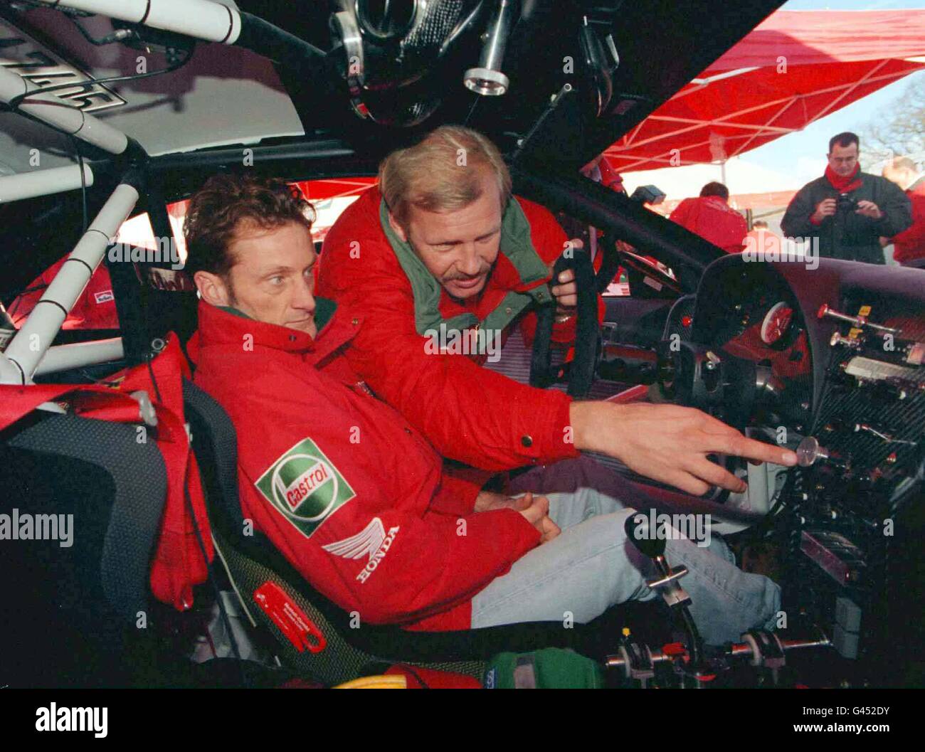 Former champion Juha Kankkunen explains the cockpit of his Toyota GT 4 to Karl Fogerty during the final preparations for this weekend's RAC Rally. The three-day event gets underway from Chester Racecourse on Saturday mornnig. PA. SEE PA STORY AUTO Rally. Stock Photo