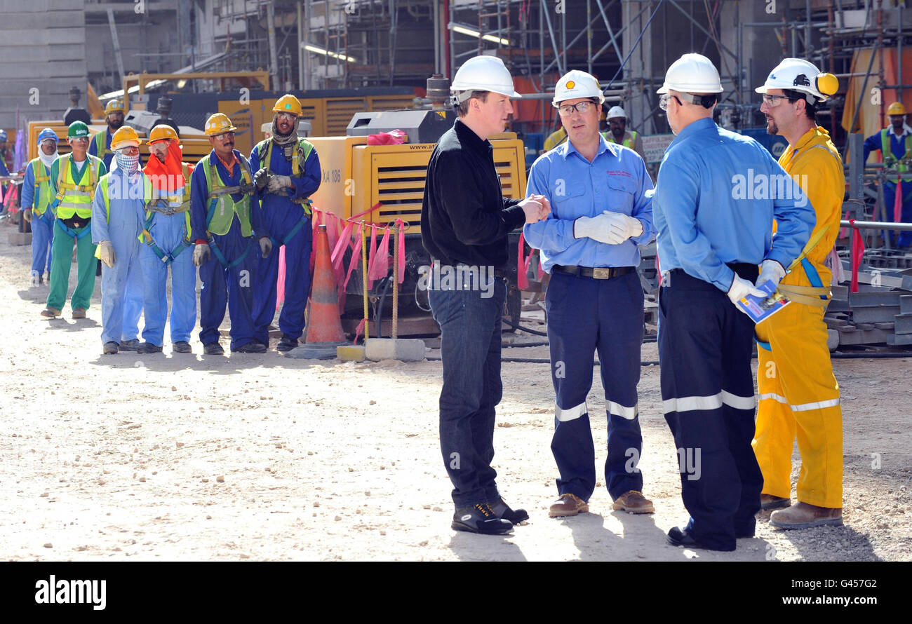 British Prime Minister David Cameron meets safety manager Talal Mehana (right) during a visit to Shell's vast new gas-to-liquid facility in Qatar, known as Pearl, with Shell executive vice president and Pearl boss Andy Brown (third right). Stock Photo