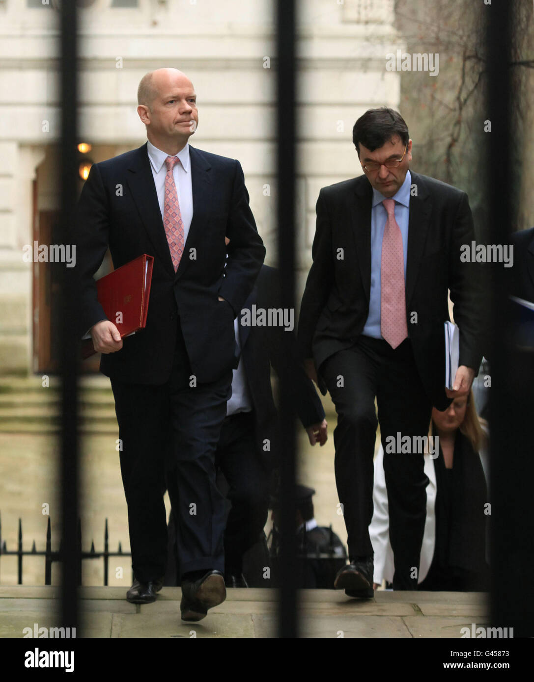 Foreign Secretary William Hague (left) arrives at Downing Street in central London, as the effort to free stranded Britons from the chaos in Libya is now well under way following a fraught start and criticism of the Government. Stock Photo