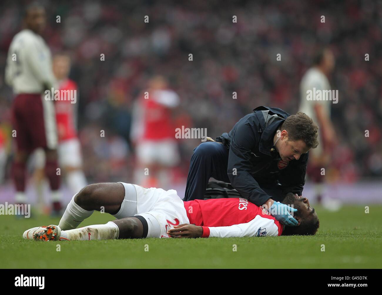 Soccer - Barclays Premier League - Arsenal v Sunderland - Emirates Stadium. Arsenal's Johan Djourou is treated for an injury Stock Photo