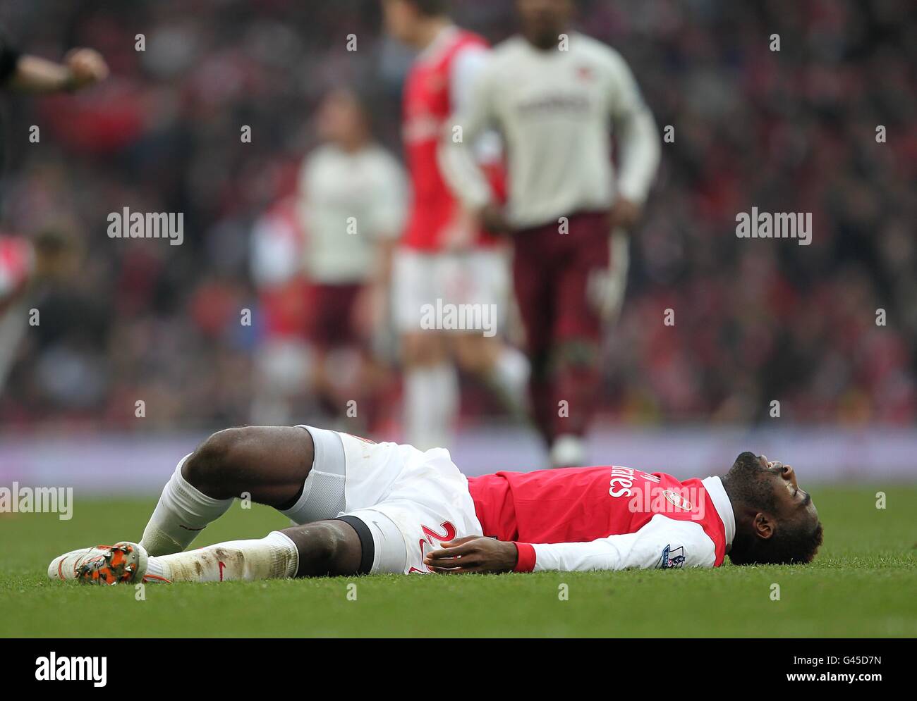 Soccer - Barclays Premier League - Arsenal v Sunderland - Emirates Stadium. Arsenal's Johan Djourou lies injured Stock Photo