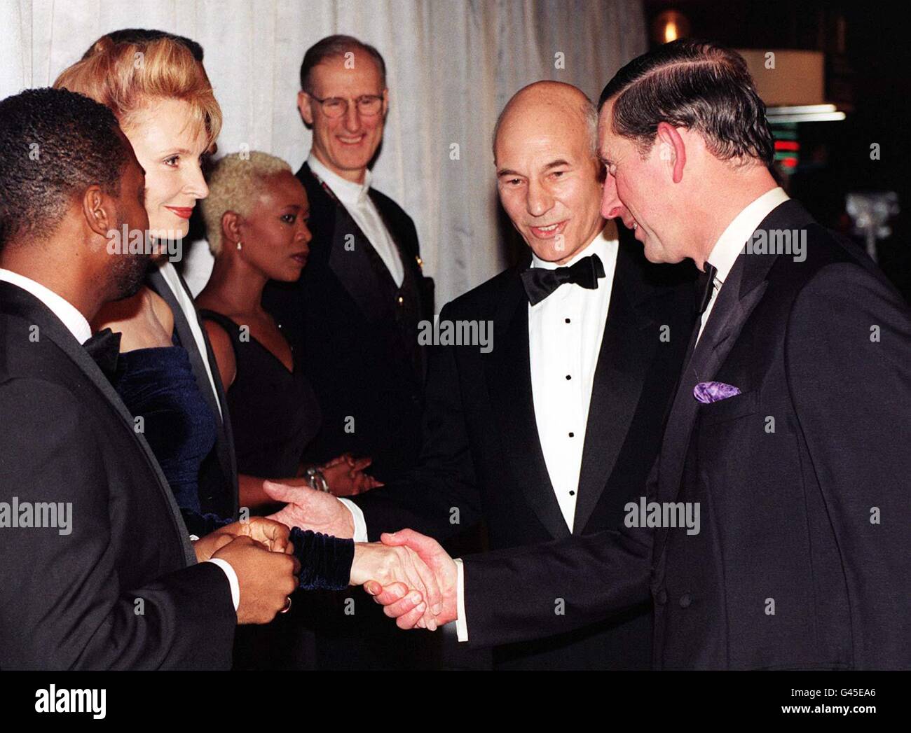 The Prince of Wales (right) is introduced to Gates McFadden, (Dr Beverly Crusher) by Patrick Stewart (Capt Jean Luc Picard) of the cast of 'Star Trek : First Contact' when the Prince attended The British Premiere of the movie at the Empire Leicester Square in London this evening (Tuesday). See PA Story SHOWBIZ Trek. Photo by Stefan Rousseau/PA. (WPA Rota Pic). Stock Photo
