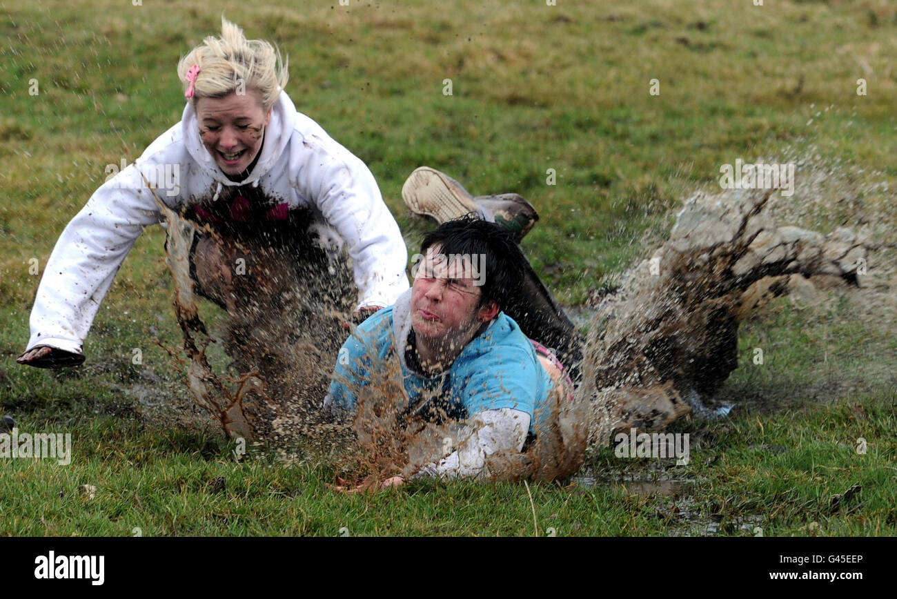 RETRANSMITTED CORRECTING BYLINE TO OWEN HUMPHREYS. People fall over while participating in the traditional Shrove Tuesday Football match at Alnwick Castle in Northumberland. Stock Photo