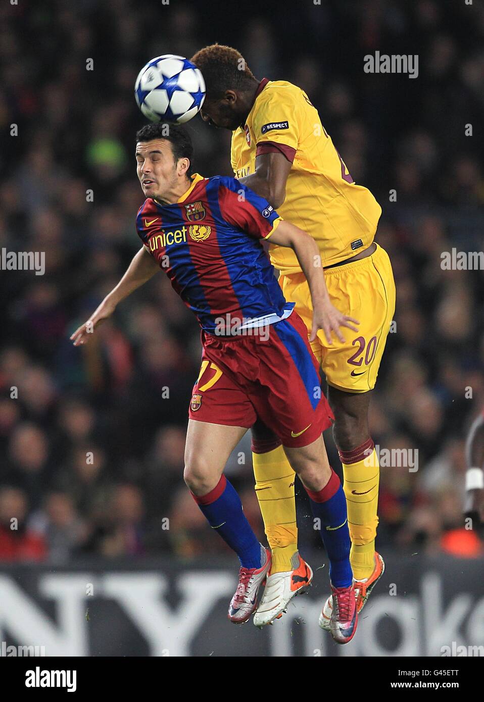 Soccer - UEFA Champions League - Round of 16 - Second Leg - Barcelona v Arsenal - Nou Camp. Barcelona's Rodriguez Pedro (left) and Arsenal's Johan Djourou (right) battle for the ball Stock Photo