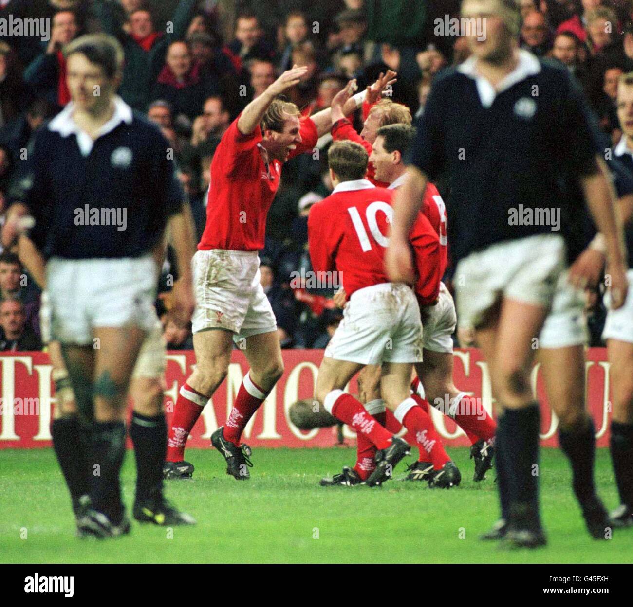 Celebrations after Neil Jenkins scored Wales third try against Scotland at Murrayfield today (Saturday). Photo Owen Humphreys/PA Stock Photo