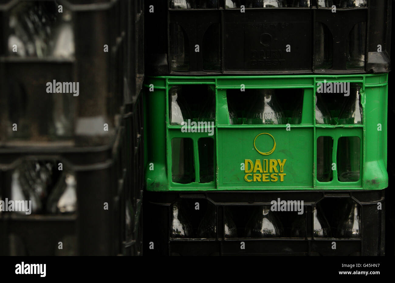 Empty Dairy Crest milk bottles in crates at the Failsworth depot in Failsworth, Greater Manchester. Stock Photo