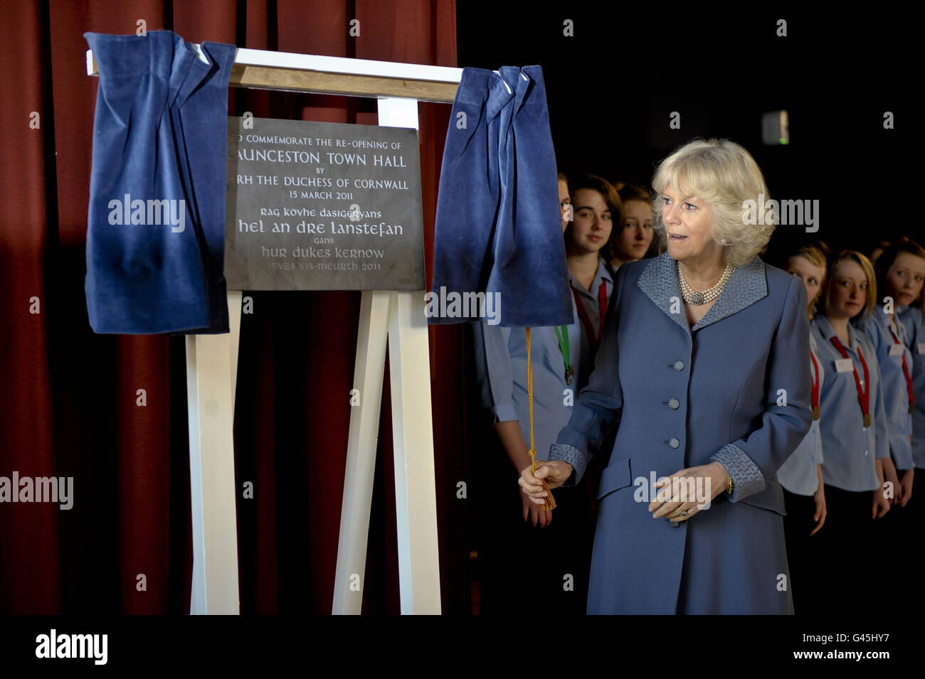 Duchess of Cornwall opens a vail to reveal a commemorative plaque towards the end of her tour during the re-opening of Launceston Town Hall, Cornwall. Stock Photo