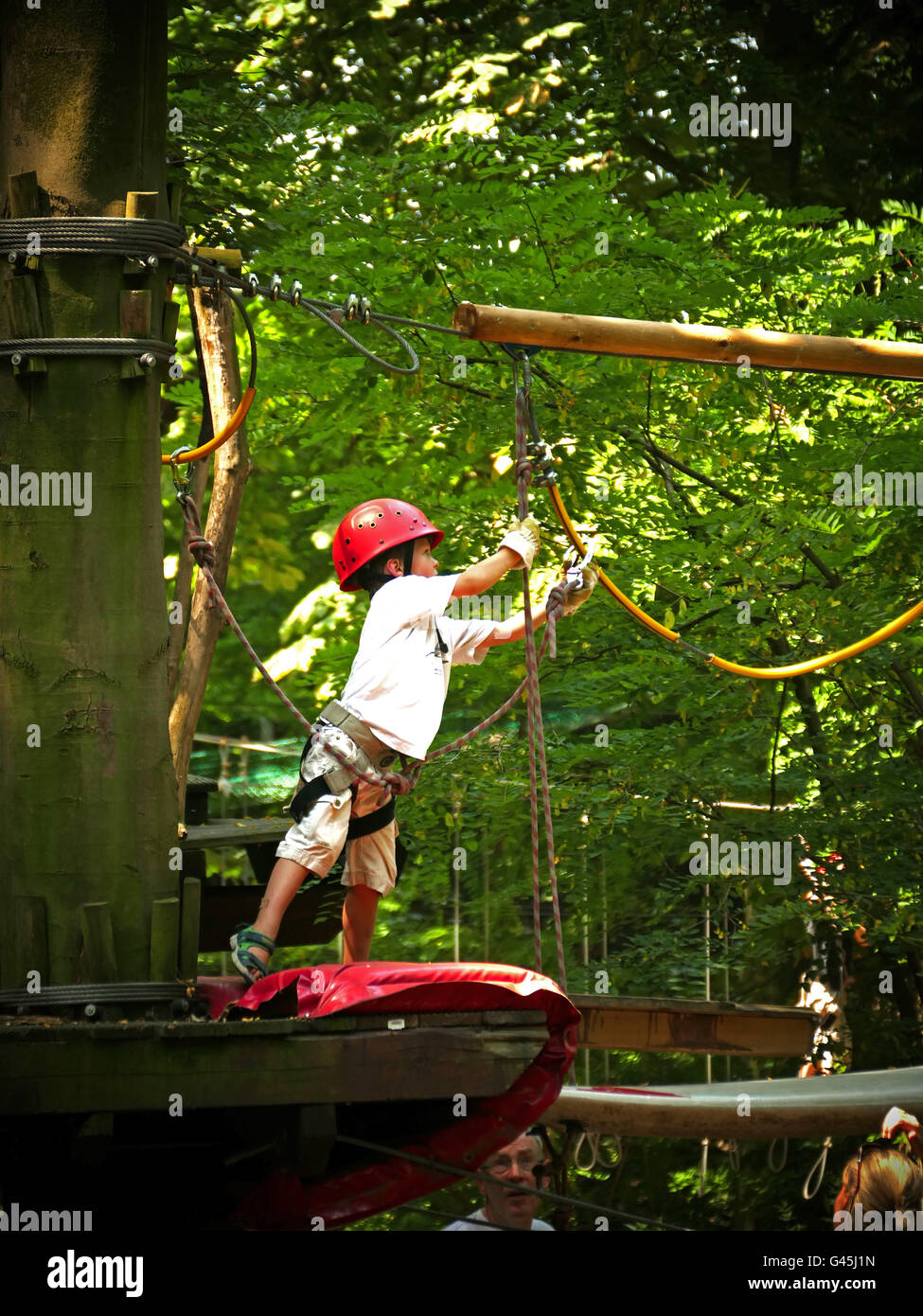 Europe Germany NRW Industrial Park Kid climbing forest adventure park Stock Photo