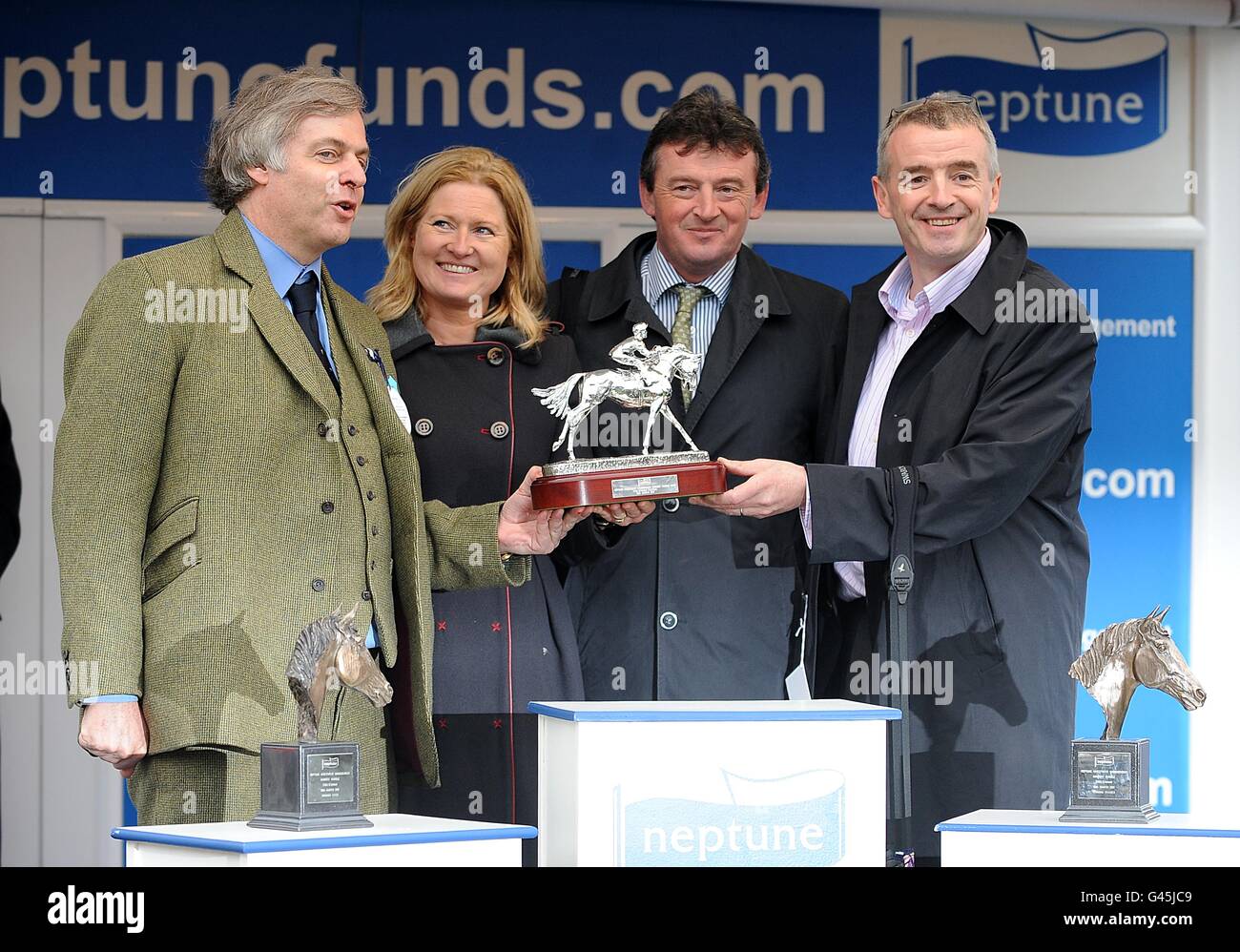 The winning party including owner and chief executive of Ryanair Michael O'Leary (farright) celebrate with the trophy after their horse First Lieutenant won the Neptune Investment Management Novices' Hurdle (Baring Bingham Novices' Hurdle) on Ladies Day, during the Cheltenham Festival Stock Photo