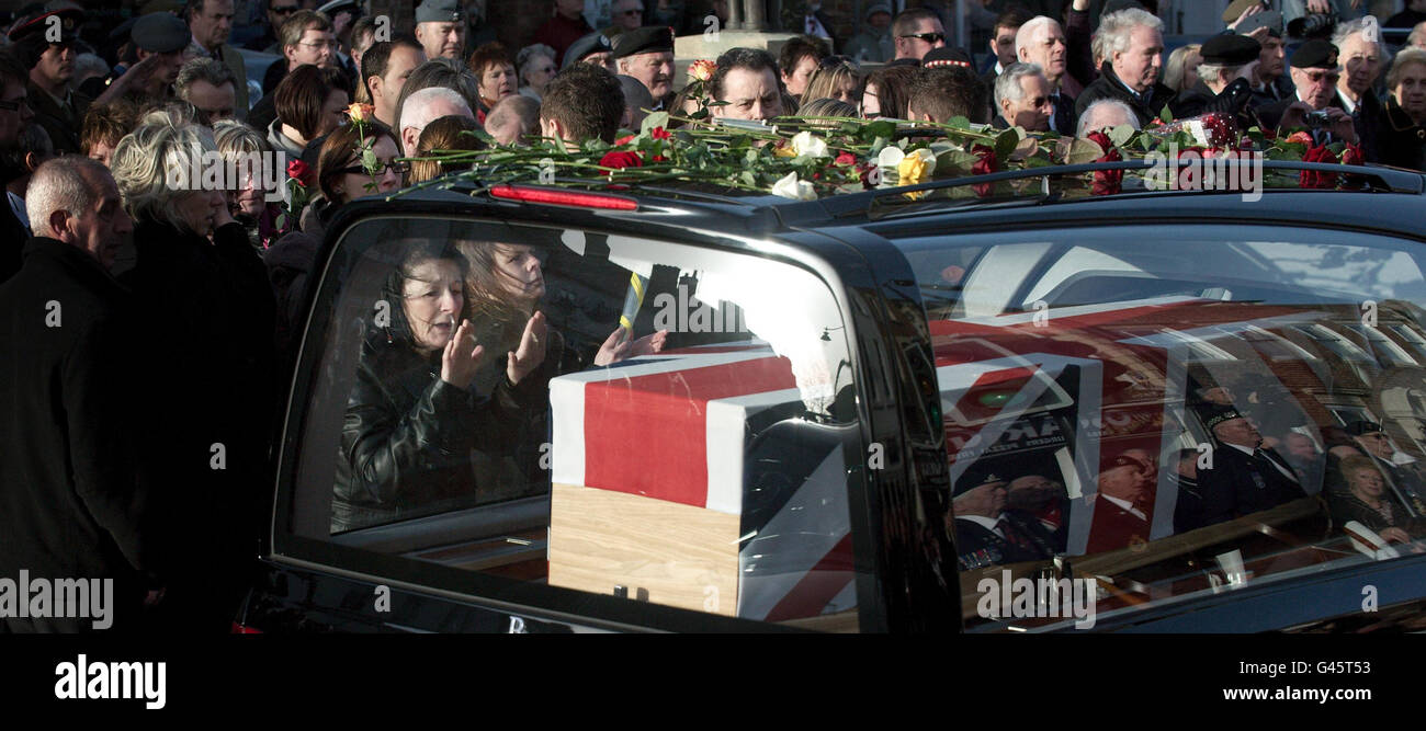 The mother of Lance Corporal Liam Tasker touches the hearse during the ...