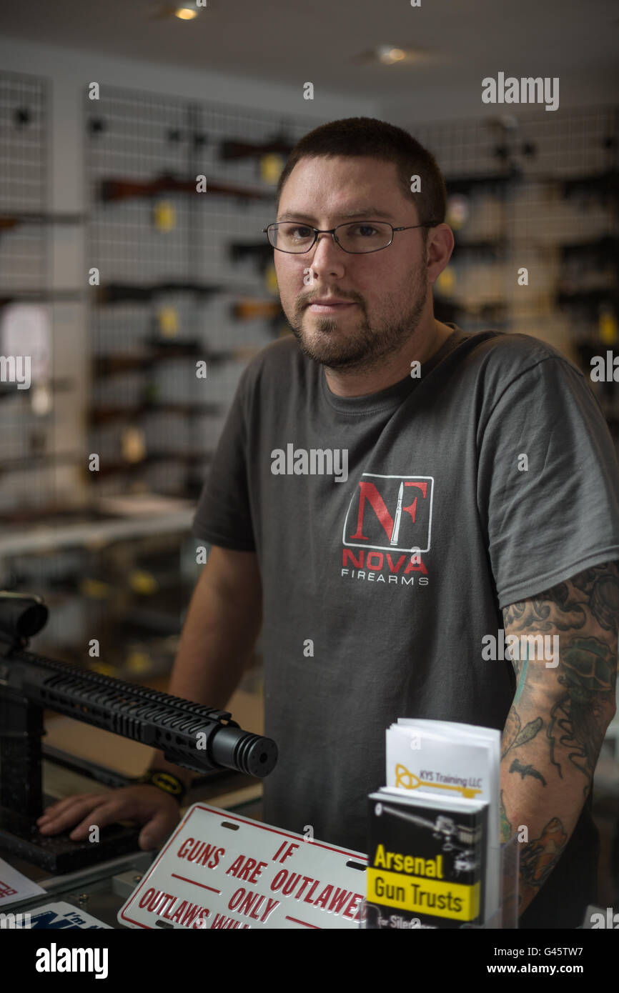 Owner of NOVA Firearms J.B. Gates behind a counter in his shop on November 4, 2015 in McLean Virginia. NOVA Firearms has had to  Stock Photo