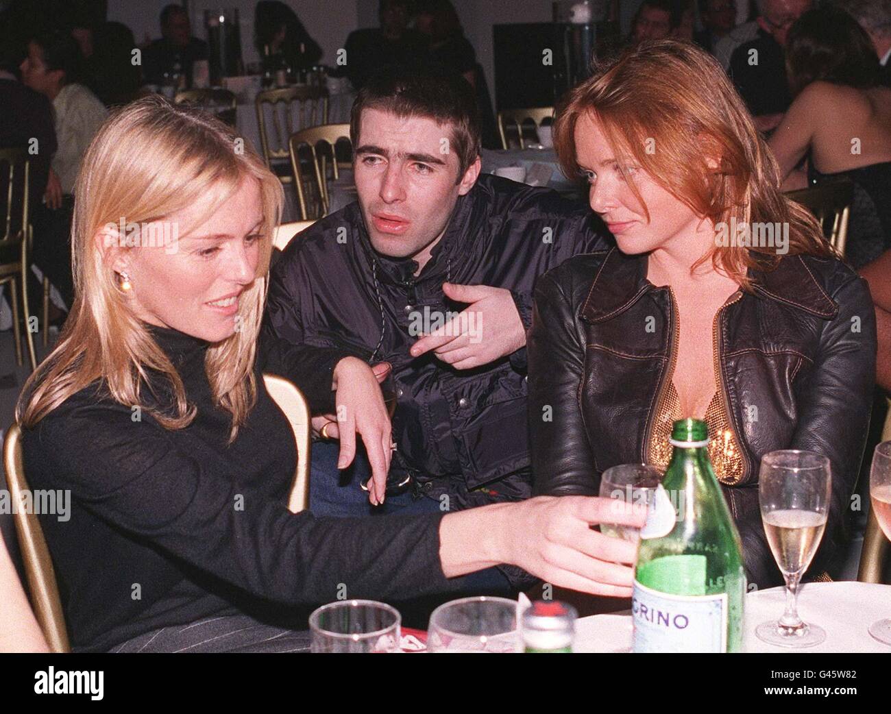 Oasis singer Liam Gallagher talks with girlfriend Patsy Kensit (left) and Stella McCartney, at last night's War Child charity auction, held at the Saatchi Gallery, in London. Photo by Sam Pearce/PA Stock Photo