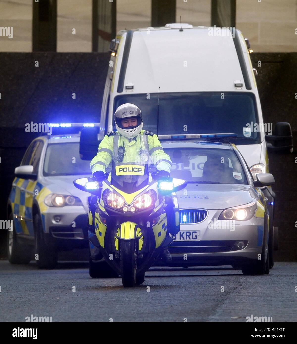 A man arrested in connection with the Stockholm suicide bombing is escorted away from Glasgow Sheriff Court. Stock Photo