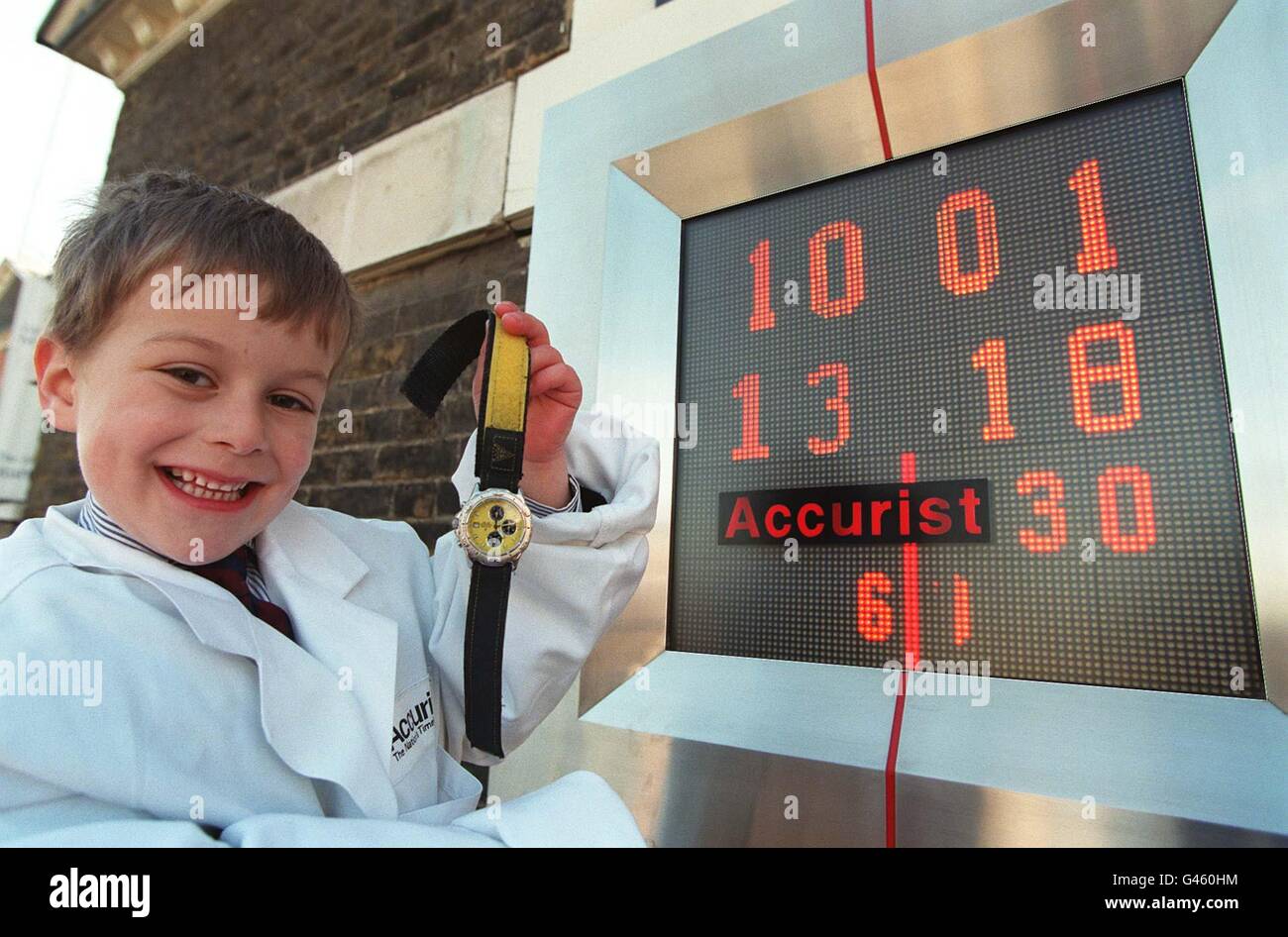 Four-year-old Gabriel Loftus, son of Andrew Loftus, managing director of Accurist, stands next to the Accurist Milleniumn Countdown Clock, sited at the centre of time on the Prime Meridian Line in Greenwich, today (Friday). At midnight GMT tonight, the clock, on the wall of the Old Royal Observatory, will register that there are precisely 1,000 days to go until the new millennium. See PA Story MILLENNIUM Clock. Photo by John Stillwell. **NOTE TO EDS: DIGITALLY ENHANCED PICTURE**. Stock Photo