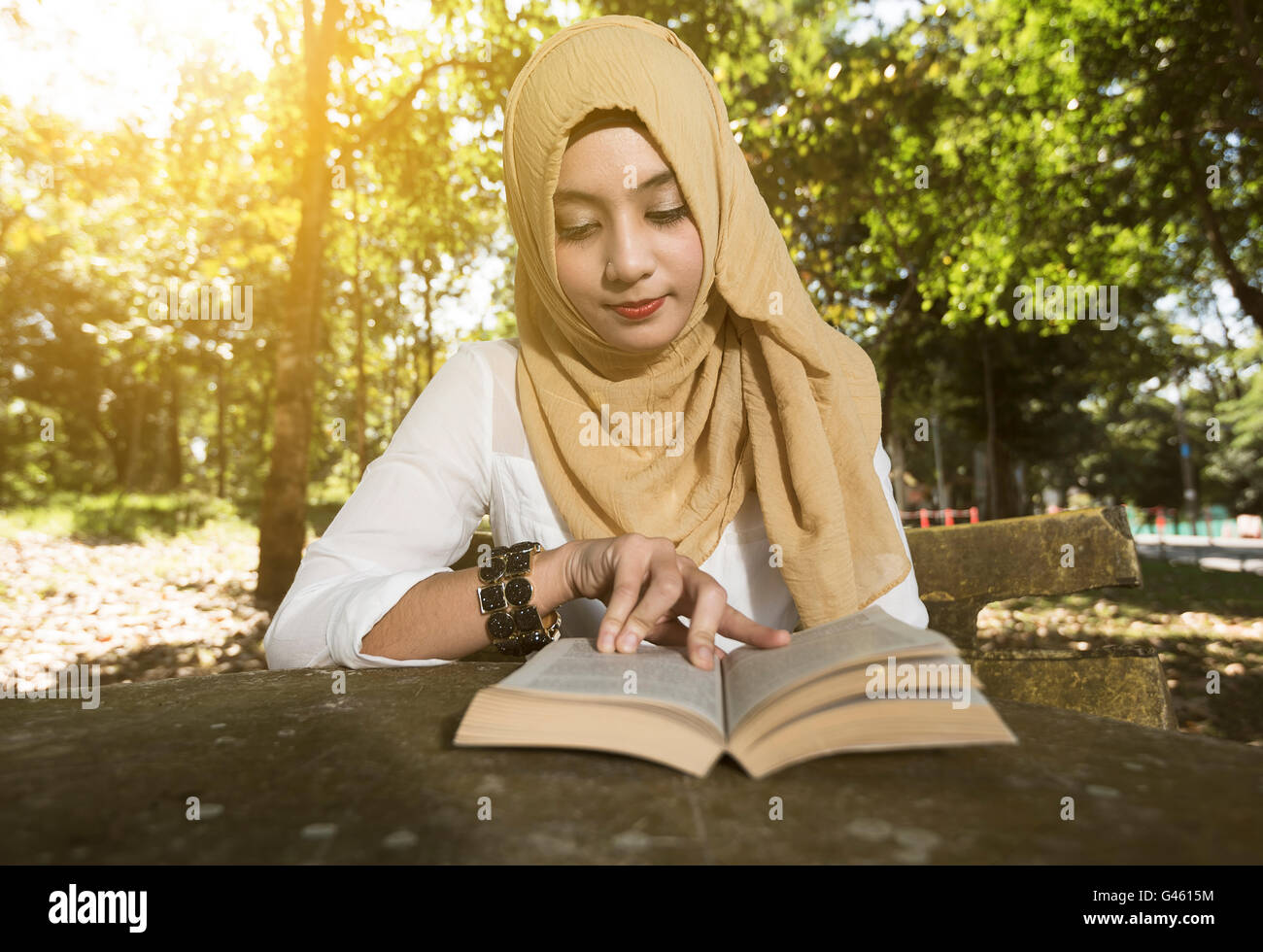 muslim woman student reading book Stock Photo