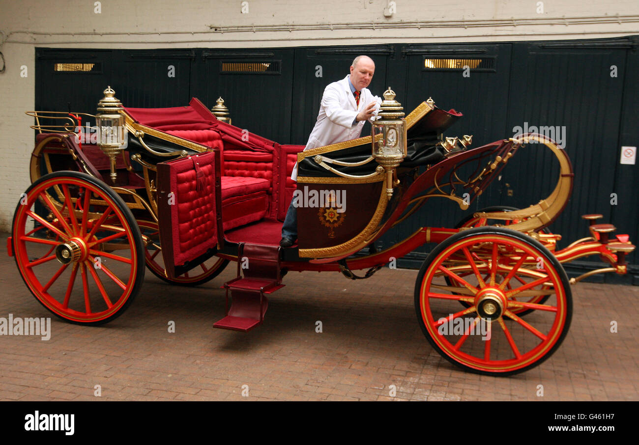 Carriage Restorer Dave Evans cleans the 1902 State Landau carriage at the Royal Mews in central London. The coach will be used to carry Prince William and Kate Middleton on their wedding day if the weather is good. Stock Photo