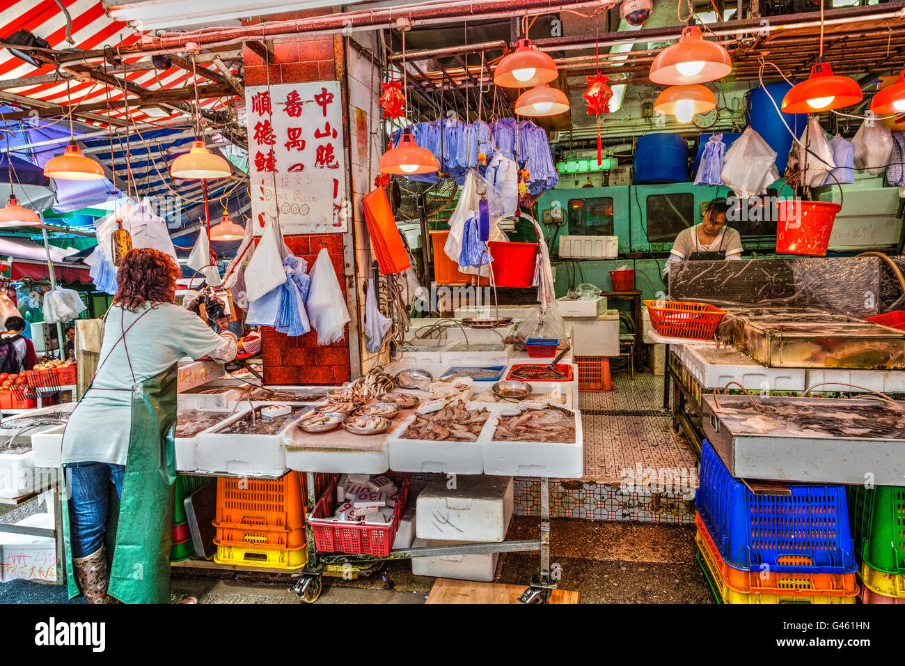 Hong Kong, China - March 30, 2015: Vendors of a live seafood store on Graham Street prepare their store for business in the Cent Stock Photo