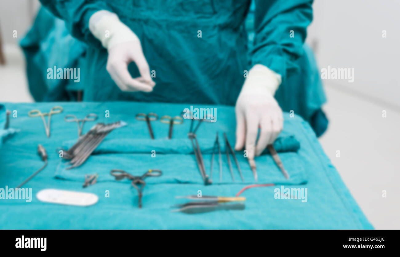 scrub nurse preparing surgical instruments for operation Stock Photo