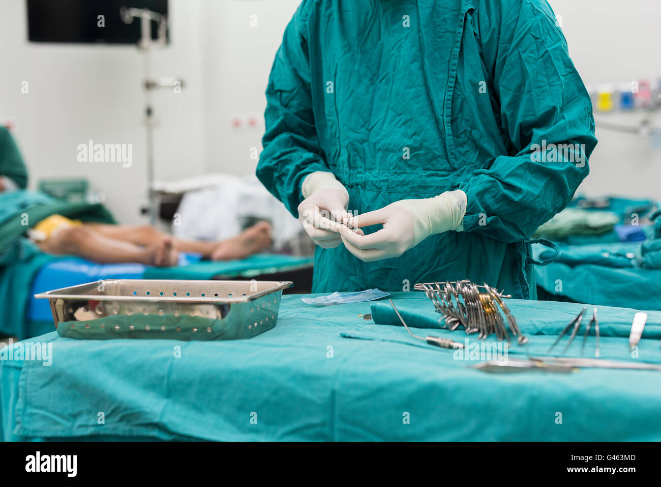 scrub nurse preparing surgical instruments for operation Stock Photo