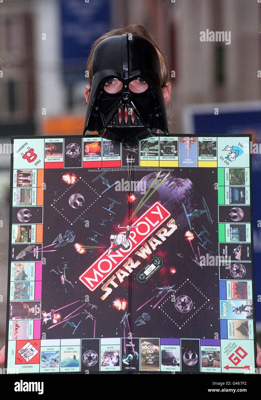 Star Wars character 'Darth Vader' holds up the limited edition version of the popular board game Monopoly. In its first revamp in 62 years, the board game replaces the familiar hat, dog, iron, boot, car and ship playing pieces with the Rebel Alliance's Luke Skywalker, Princess Leia, Han Solo, R2-D2, and Chewbacca, and baddies Darth Vader, Boba Fett and a Stormtrooper. The game was unveiled at today's (Mon) British International Toy and Hobby Fair at Olympia, London.  See PA story CONSUMER Monopoly. Photo by Sean Dempsey. Stock Photo